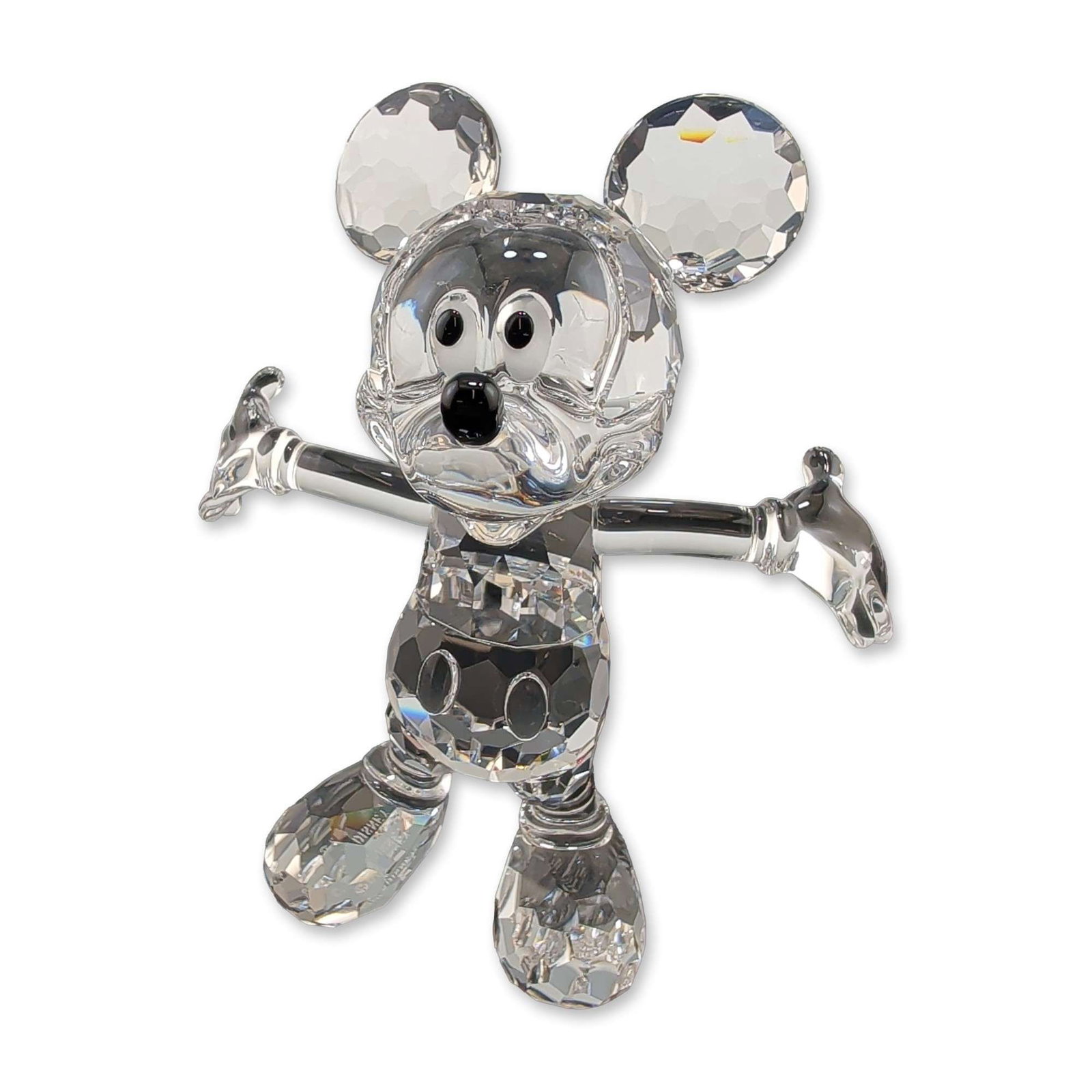 Swarovski Disney Crystal Mickey Mouse Figurine: Swarovski Disney Collection Mickey Mouse figurine in faceted lead crystal, featuring the character in a celebratory standing pose with open arms. The figure is constructed with a clear faceted crystal