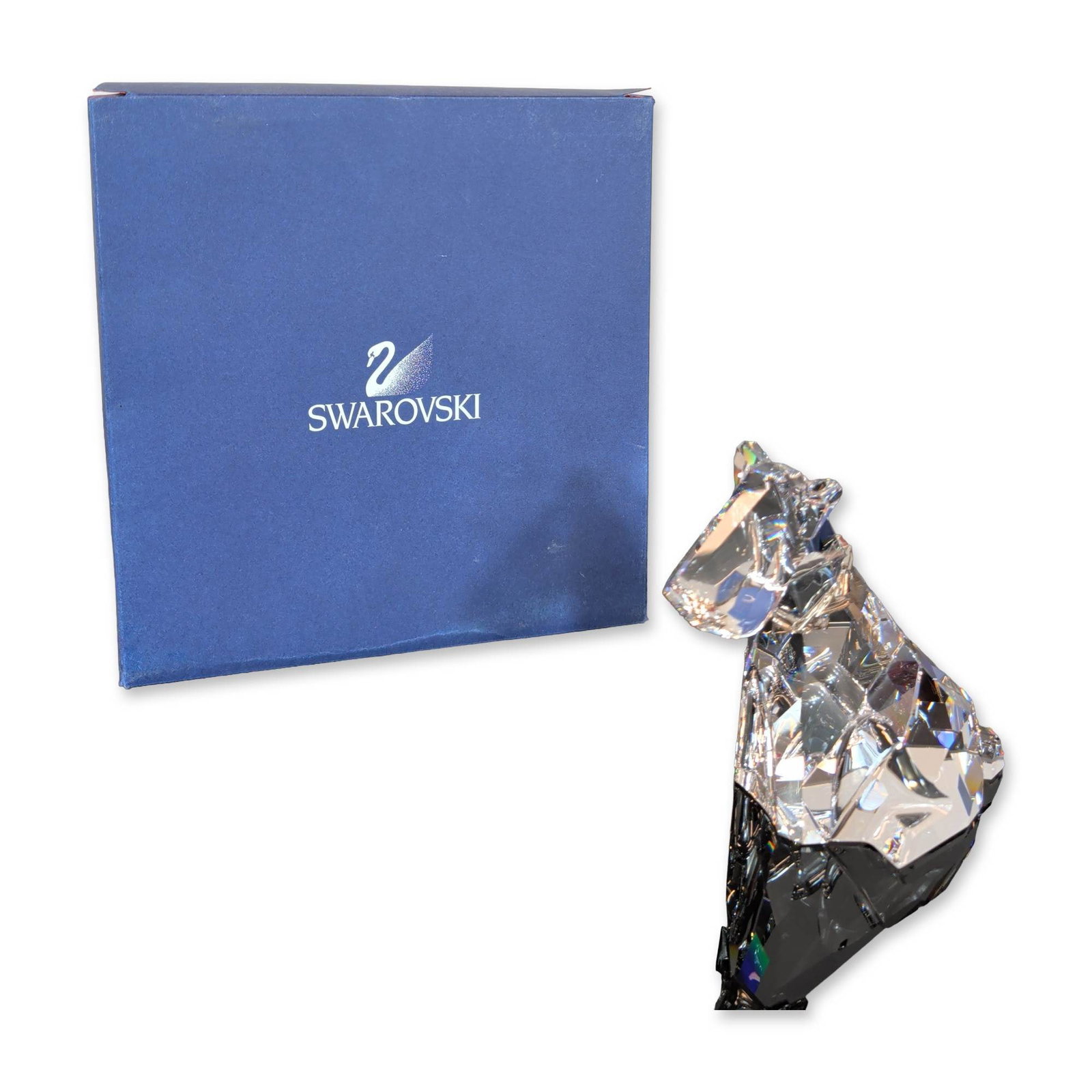 Swarovski Crystal Symbols Figurine, Dog: Crafted in clear faceted lead crystal. Etched with the Swarovski swan logo, SCS 2011 mark, and designer signature on the base. Presented with original blue Swarovski box and black outer sleeve. Model 