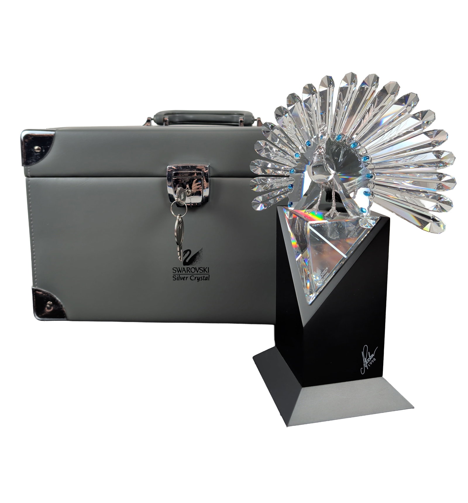 Swarovski 1998 Limited Edition Peacock Figurine: Swarovski Silver Crystal "The Peacock" figurine designed by Adi Stocker, 1998. The piece is constructed in full-cut faceted clear lead crystal featuring an expansive fan-shaped tail accented by circul