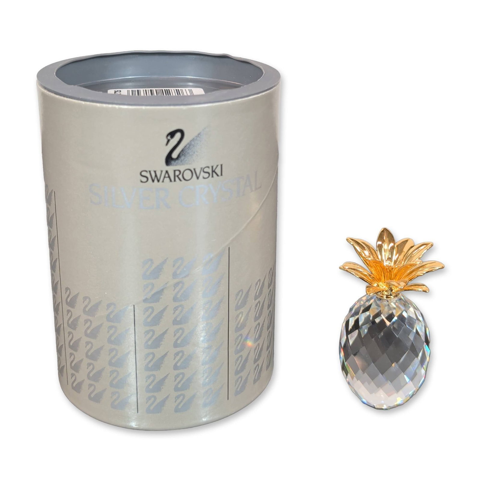 Swarovski Silver Crystal Pineapple Figurine: Swarovski Silver Crystal small pineapple figurine featuring a faceted clear crystal ovoid body and gold-tone metal leaves. The base facet is etched with the Swarovski swan logo and copyright symbol. A