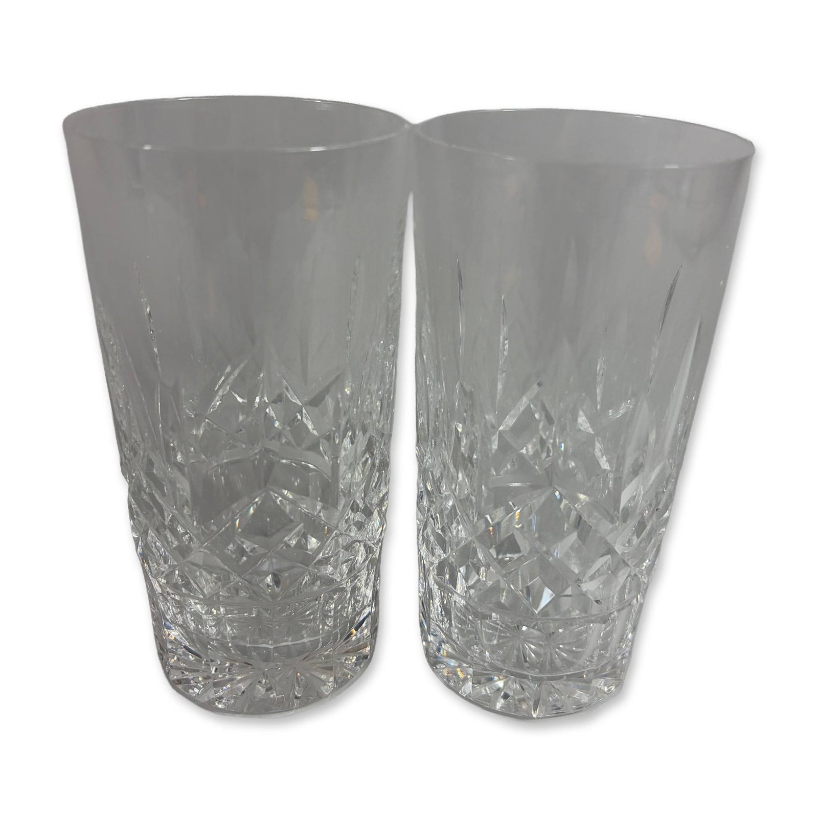 Pair of Waterford Crystal Highball Glasses: Pair of highball glasses in cut lead crystal, featuring a horizontal band of diamond-cut cross-hatching at the base with vertical wedge-shaped fan cuts extending toward the rim. Each base is decorated