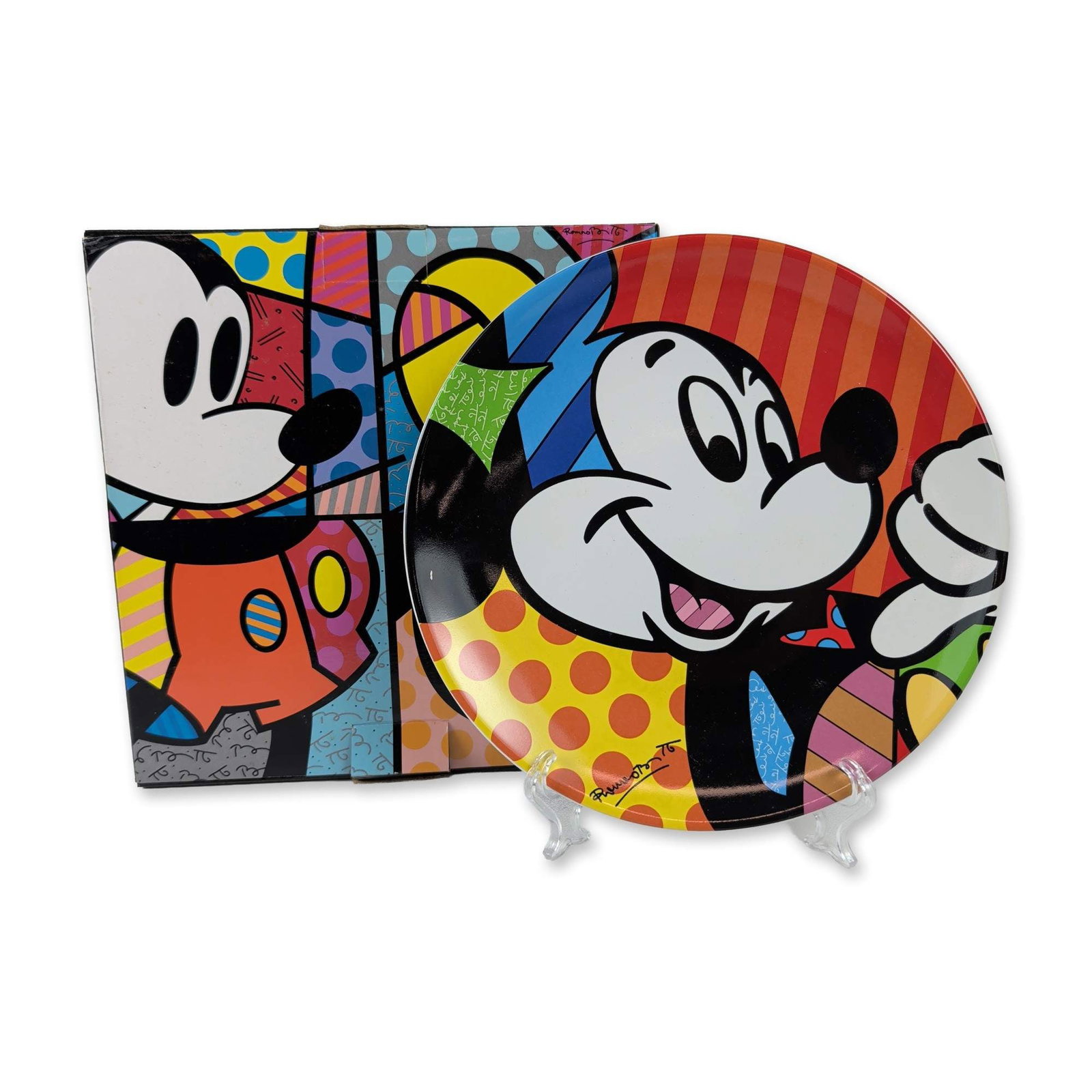 Disney by Britto Mickey Mouse Ceramic Plate: Disney by Romero Britto. Decorative glazed ceramic plate featuring a vibrant Pop Art depiction of Mickey Mouse. The composition utilizes the artist's signature style of bold black outlines with segmen