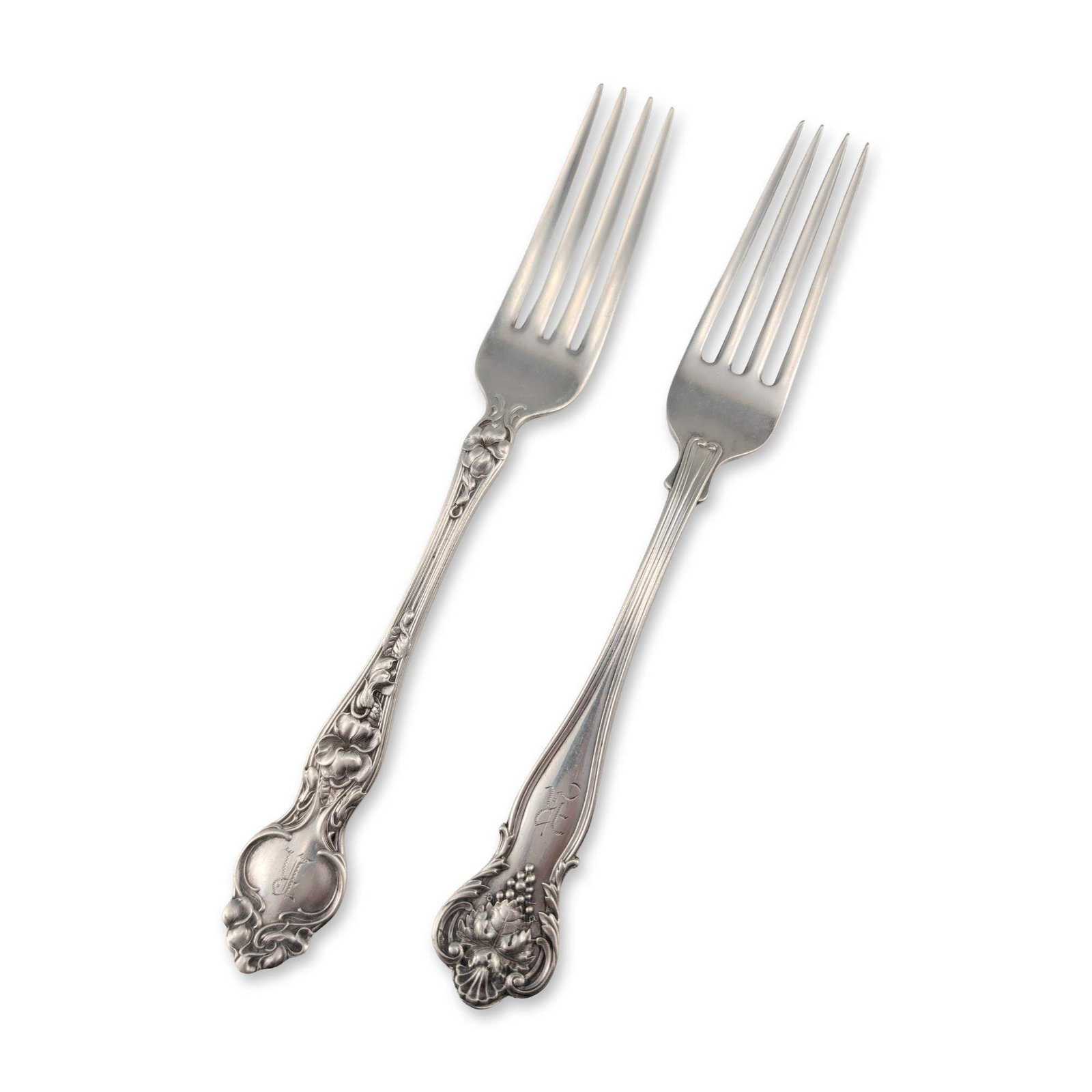 Two Sterling Silver Art Nouveau Forks: Two sterling silver forks in the Art Nouveau style. One fork features a naturalistic grape leaf and vine repousse motif at the handle terminal and base of the tines. The reverse neck is stamped with a