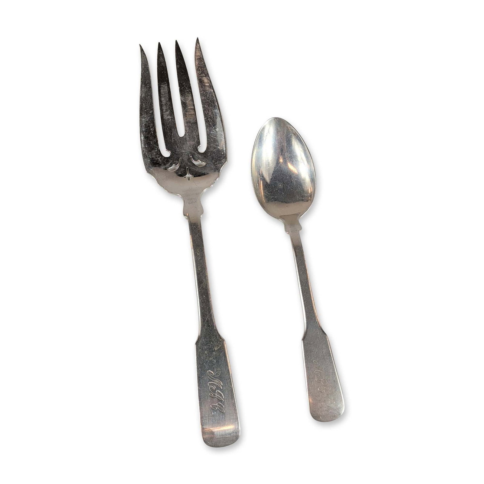2pc Sterling Silver Fiddle Thread Serving Fork and Teaspoon: Two sterling silver pieces in the Fiddle Thread pattern, consisting of one cold meat serving fork with decorative scroll piercings at the base of the tines and one teaspoon. Both pieces feature should