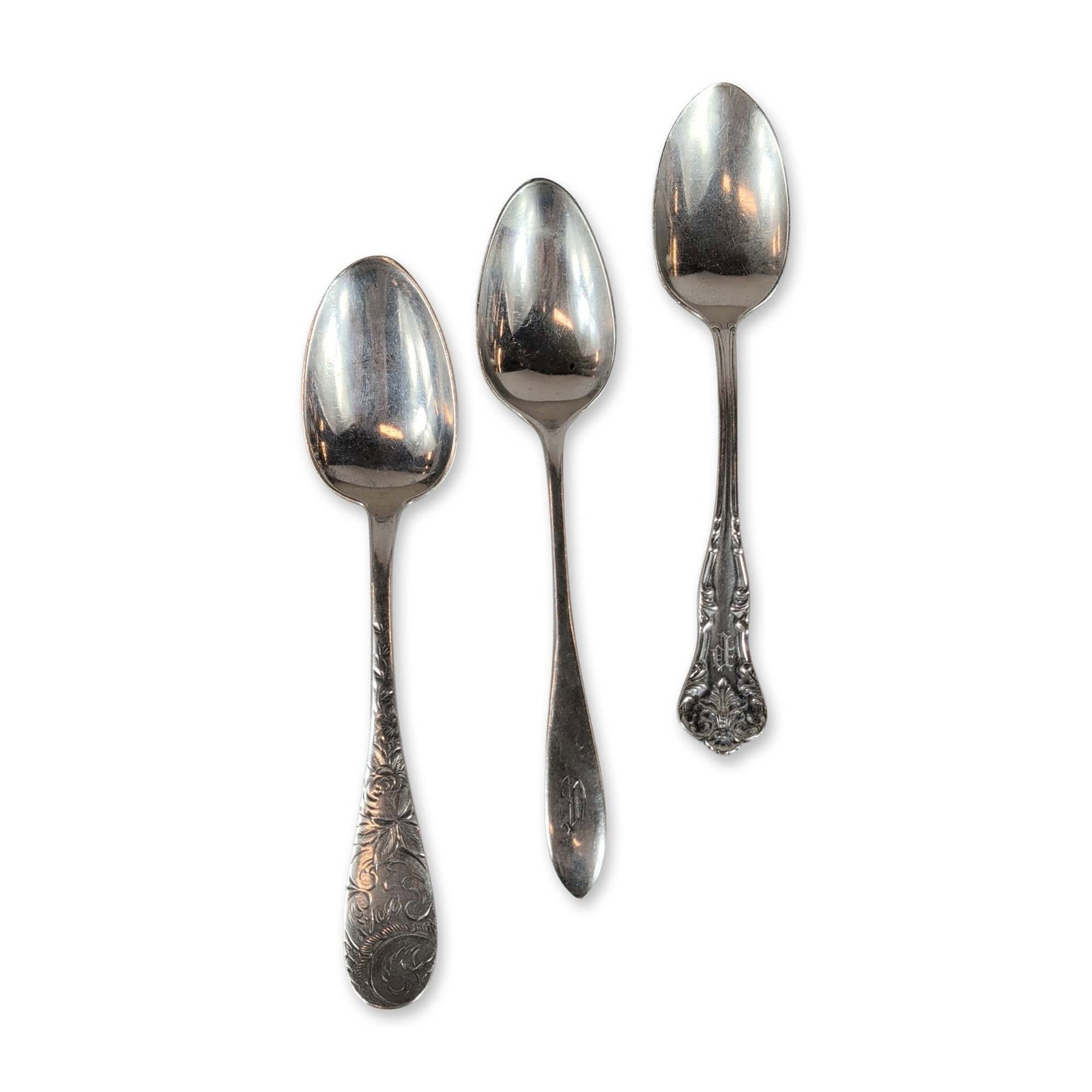 3pc American Sterling Silver Teaspoons: Group of three American sterling silver teaspoons by various makers. The first spoon features high-relief Rococo style scrolls, acanthus leaves, and a shell terminal. Stamped STERLING with hallmarks.