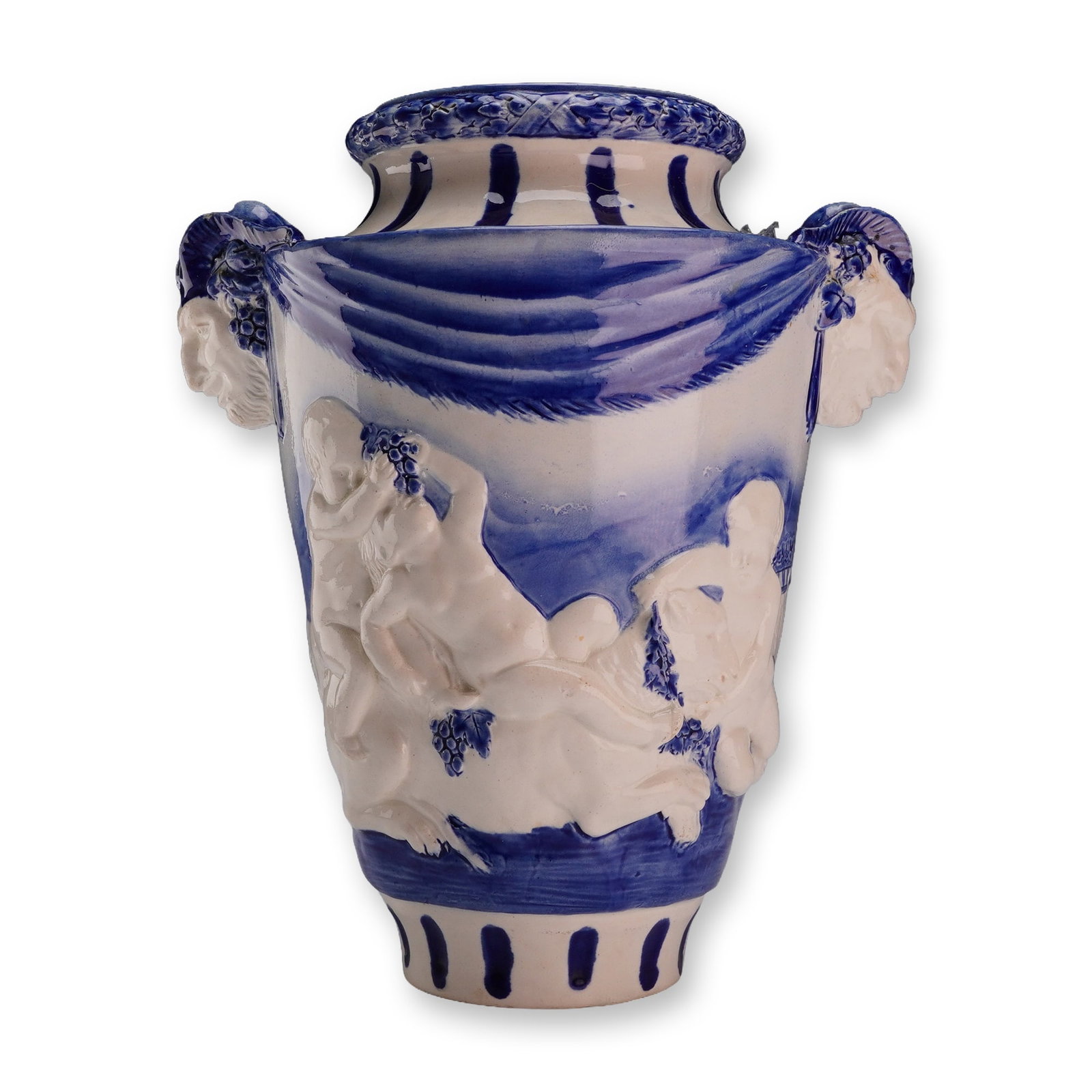Vintage Wedgwood and Mintons Blue and White Urn with Raised Cherubs and Grapes: This large, glazed earthenware urn-form vase features Neoclassical style decoration in blue and white. The body is decorated with high-relief molded figures of raised cherubs engaged in a grape harves