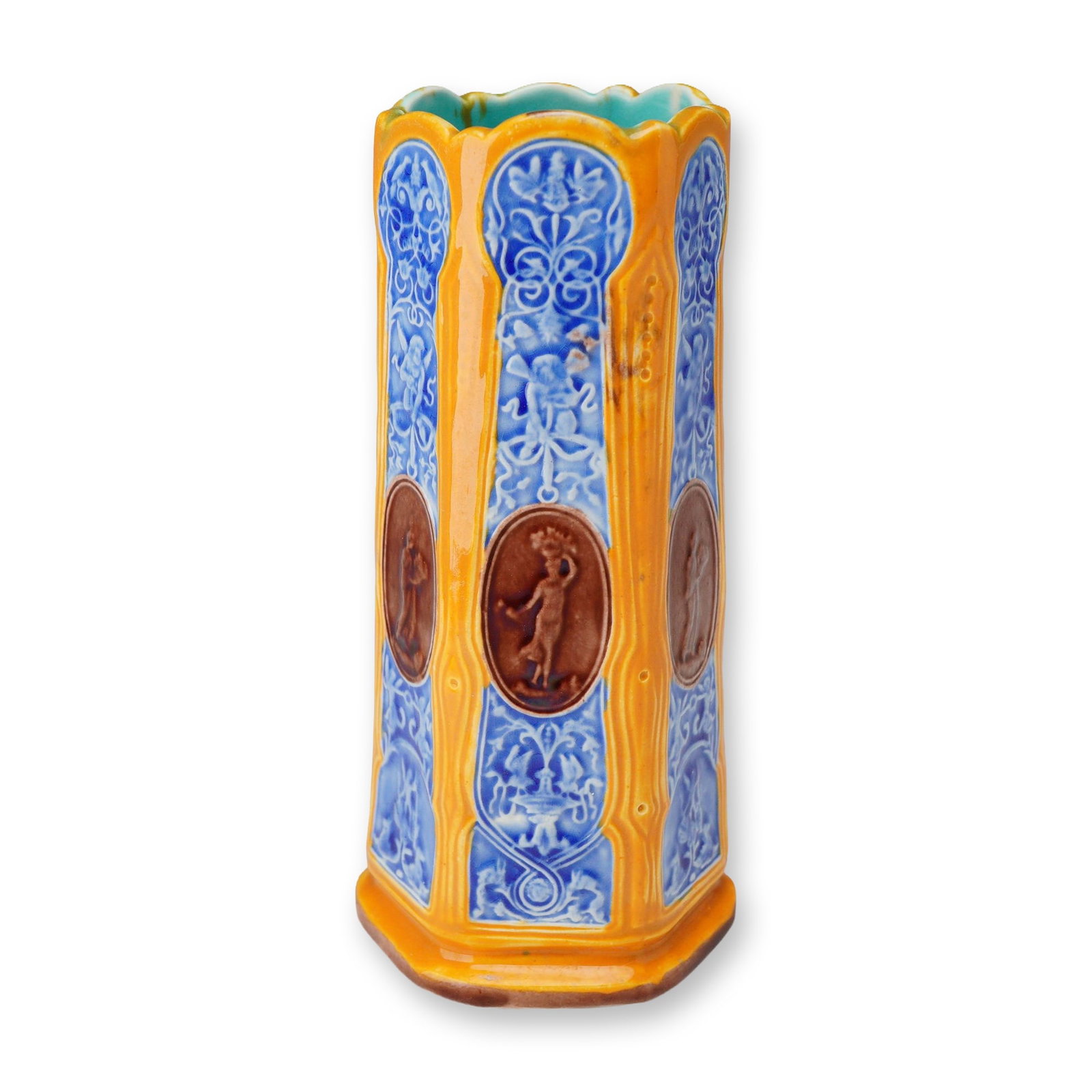 Wedgwood Victorian Majolica Hexagonal Spill Vase with Classical Medallions: A Victorian majolica spill vase manufactured by Wedgwood, featuring an Aesthetic Movement design dating to approximately 1873. The earthenware vessel is of hexagonal form with a scalloped rim, taperin