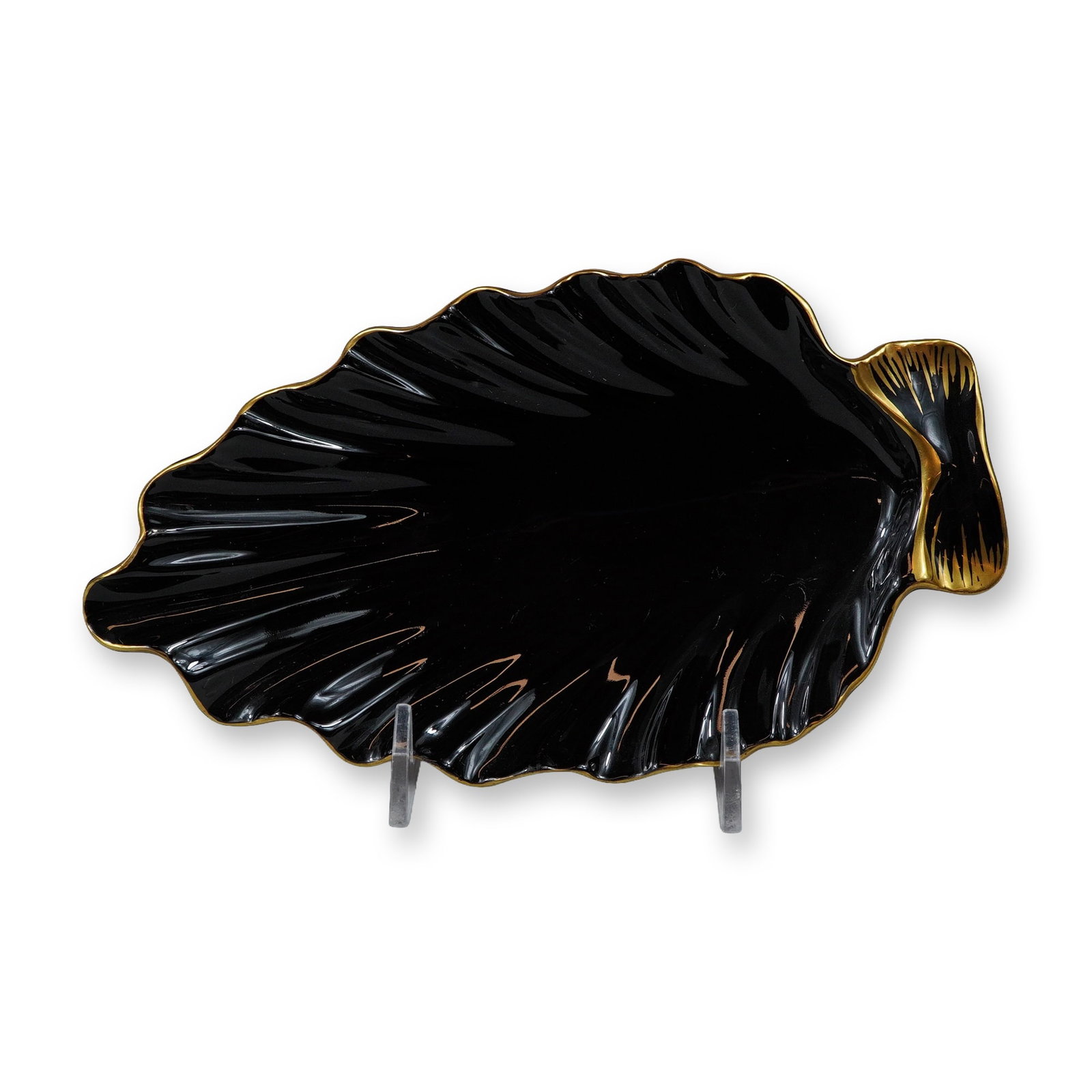 Wedgwood Gold on Glazed Black Basalt Leaf Shaped Olive Dish: This mid-20th-century olive dish was produced by Wedgwood in England. The piece is crafted from black basalt, a fine-grained stoneware, and finished with a monochromatic high-gloss black glaze. It is
