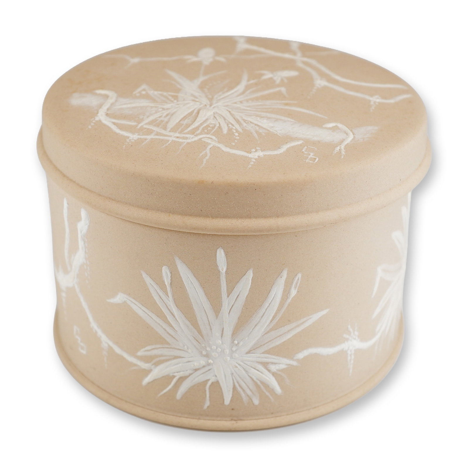 Wedgwood Cane Jasperware Lidded Trinket Box with Botanical Relief: A cylindrical lidded trinket box manufactured by Wedgwood in England. The piece is crafted from a matte, unglazed cane-colored stoneware, a variation of the company's jasperware. The exterior