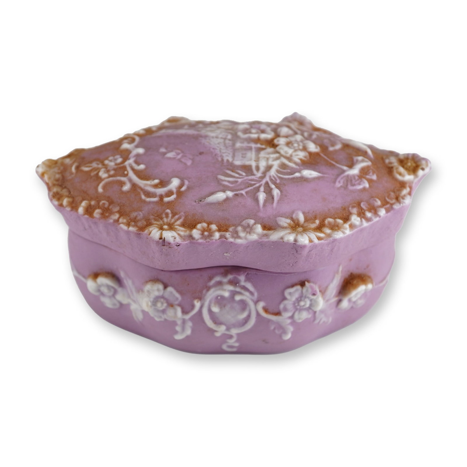 Lavender Jasperware Style Lidded Trinket Box with White Sprigged Relief: A small, oval lidded trinket box produced in the jasperware style, featuring a lavender-toned matte exterior. The vessel is decorated with applied white sprigged relief ornamentation. The slightly