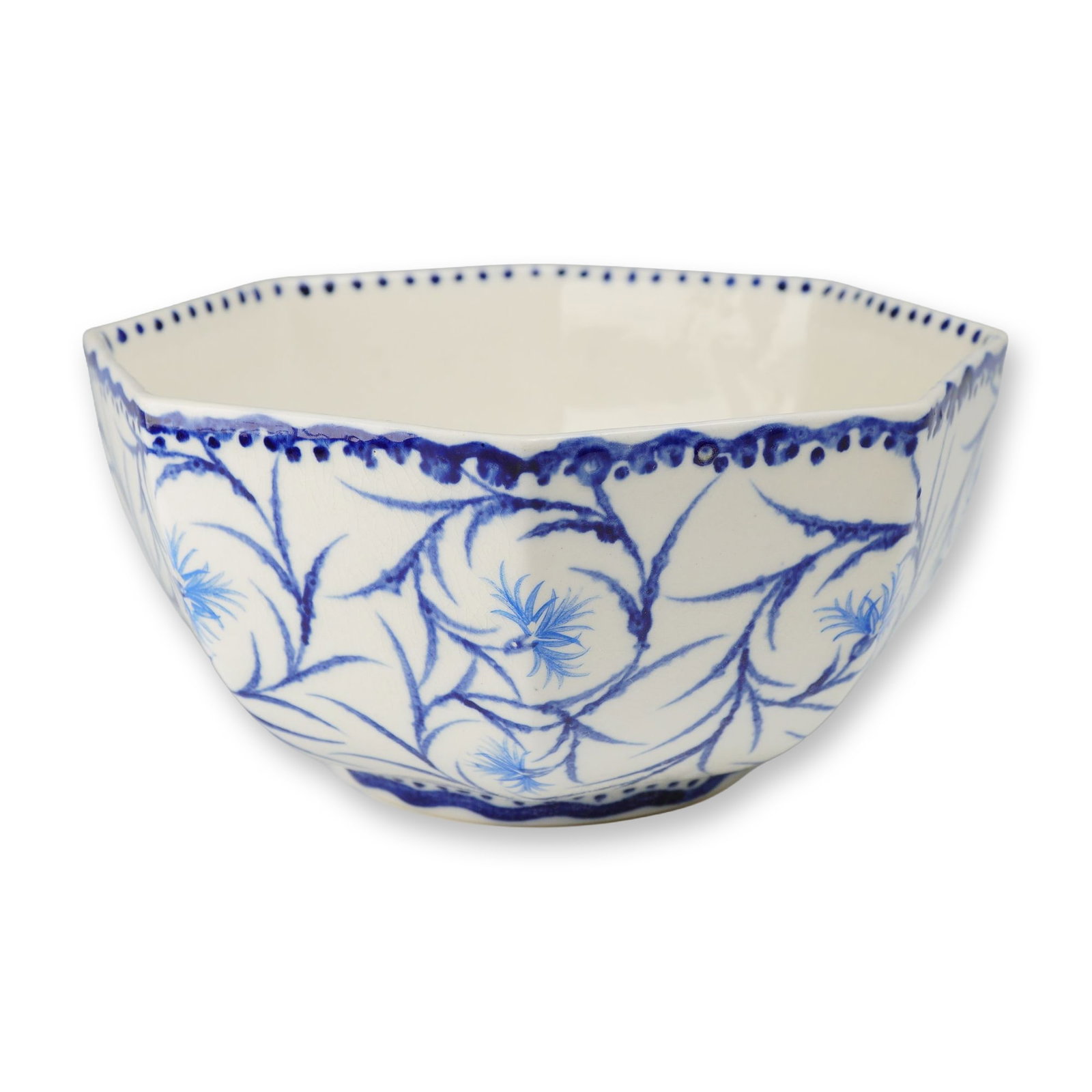 Wedgwood Octagonal Ceramic Bowl with Blue Decoration: This octagonal ceramic bowl, produced by Wedgwood and made in England, features hand-painted blue underglaze decoration in the cornflower pattern. The vessel is designed with eight faceted sides that 