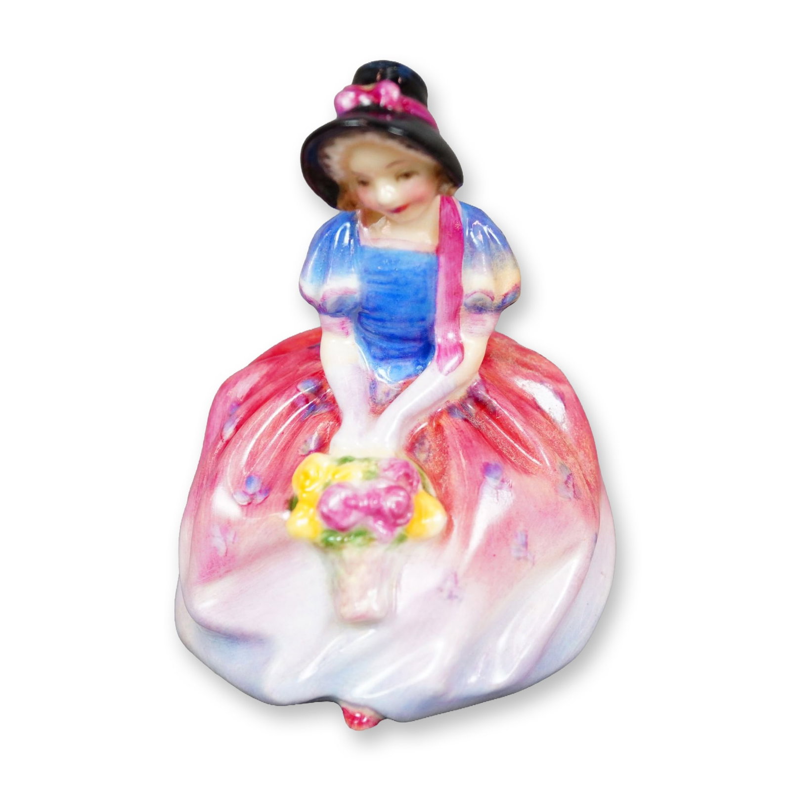 Royal Doulton Figurine, Monica M66: Hand painted figure of a woman in a pink-purple floral pattern dress, shown holding a basket of flowers. Royal Doulton backstamp. Dimensions: 2.25"L x 2.25"W x 3"H Manufacturer or Brand: Royal Doulton