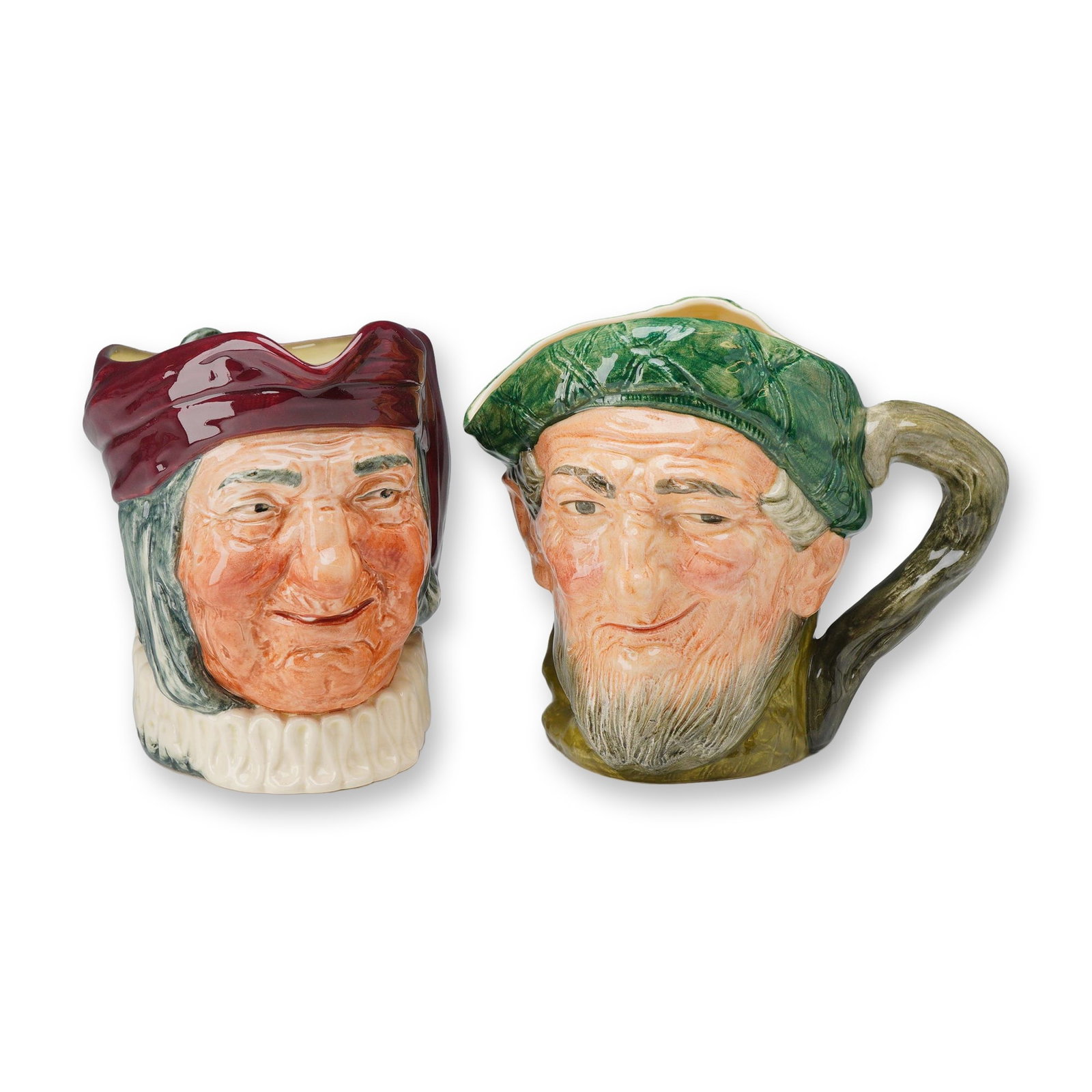 2pc Royal Doulton Large Character Jugs, Simon the Cellarer D5504 and Auld Mac D5823: Simon the Cellarer depicts a smiling figure in a deep red hood and white ruff collar, featuring a handle molded in the form of hanging keys and the name Simon molded on the reverse. Auld Mac depicts a