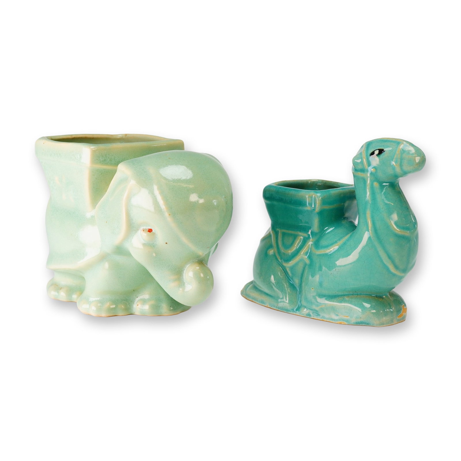 Weller Cactus Camel & USA Elephant Planter: This lot consists of two figural ceramic animal planters in a blue green glaze finish. The first item is a kneeling camel finished in a vibrant teal aqua monochromatic crackle glaze, featuring an inte