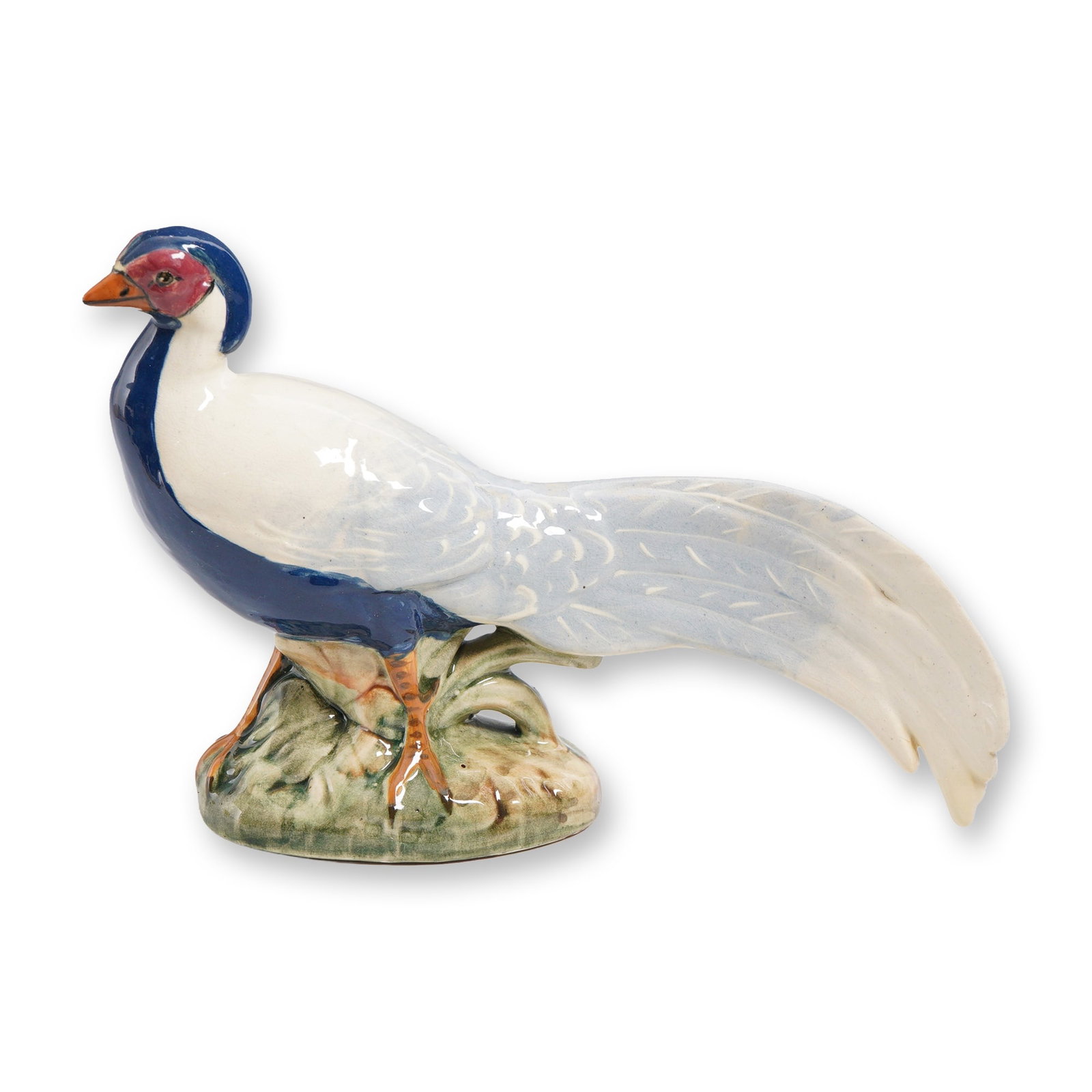 Weller Pottery Brighton Pheasant Figurine: A Weller Pottery Brighton pheasant figurine, hand-painted in naturalistic tones of cobalt blue, white and russet with finely modeled plumage and perched upon a green mottled base. The underside is