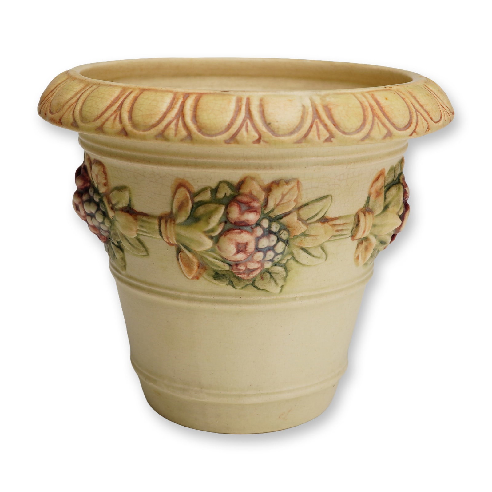 Weller Pottery Fruit and Foliate Swag Jardiniere, Flemish: An American art pottery jardiniere or cachepot produced by Weller Pottery in the Flemish pattern, circa 1915. The ceramic vessel is of tapered cylindrical form, featuring a wide, flared rim with