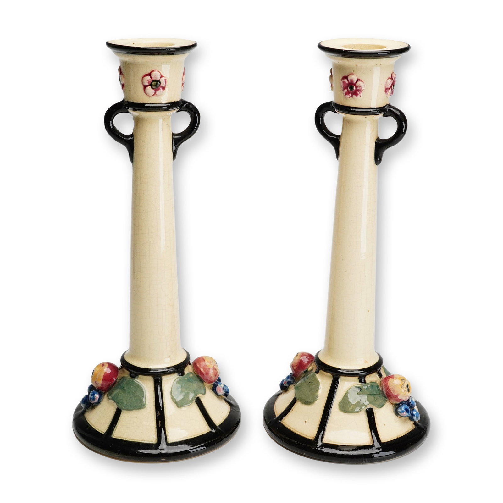 Pair of Weller Pottery Fruit and Berry Candle Holders, Noval: The Noval line by Weller Pottery, Zanesville, Ohio, dating to the Art Deco period, circa 1920. These earthenware pieces feature a cream-glazed body with a slender, tapered stem flanked by two small lo