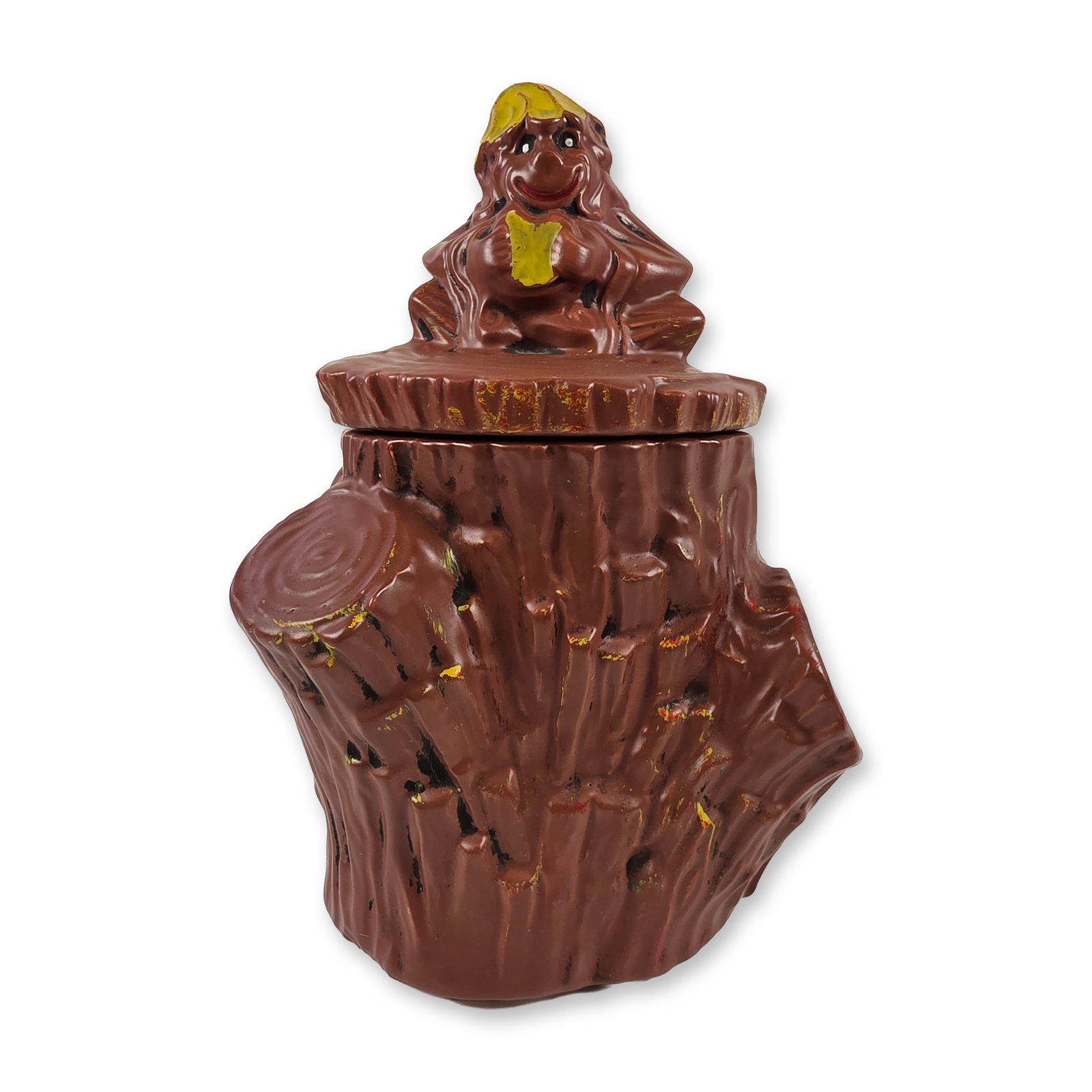 McCoy Monkey on Stump Cookie Jar: Mid-century novelty earthenware cookie jar by McCoy Pottery. The piece is modeled as a textured tree stump with a figural monkey character seated on the lid. Finished in a dark brown glaze with