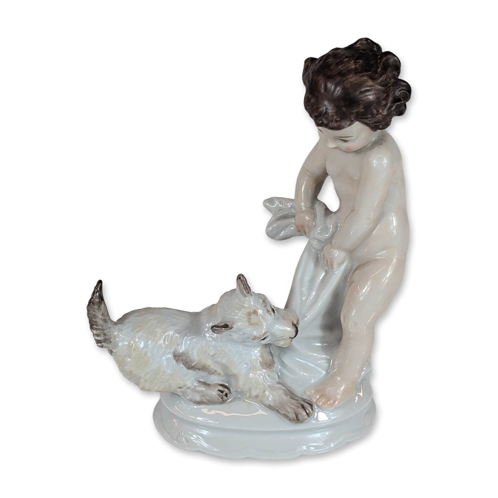 Rosenthal Porcelain Figurine by Max Hermann Fritz, Child with Dog: Rosenthal porcelain figurine in glazed polychrome porcelain, designed by Max Hermann Fritz (German, 1873-1948). The piece depicts a nude toddler with dark curly hair leaning over a white shaggy-haired
