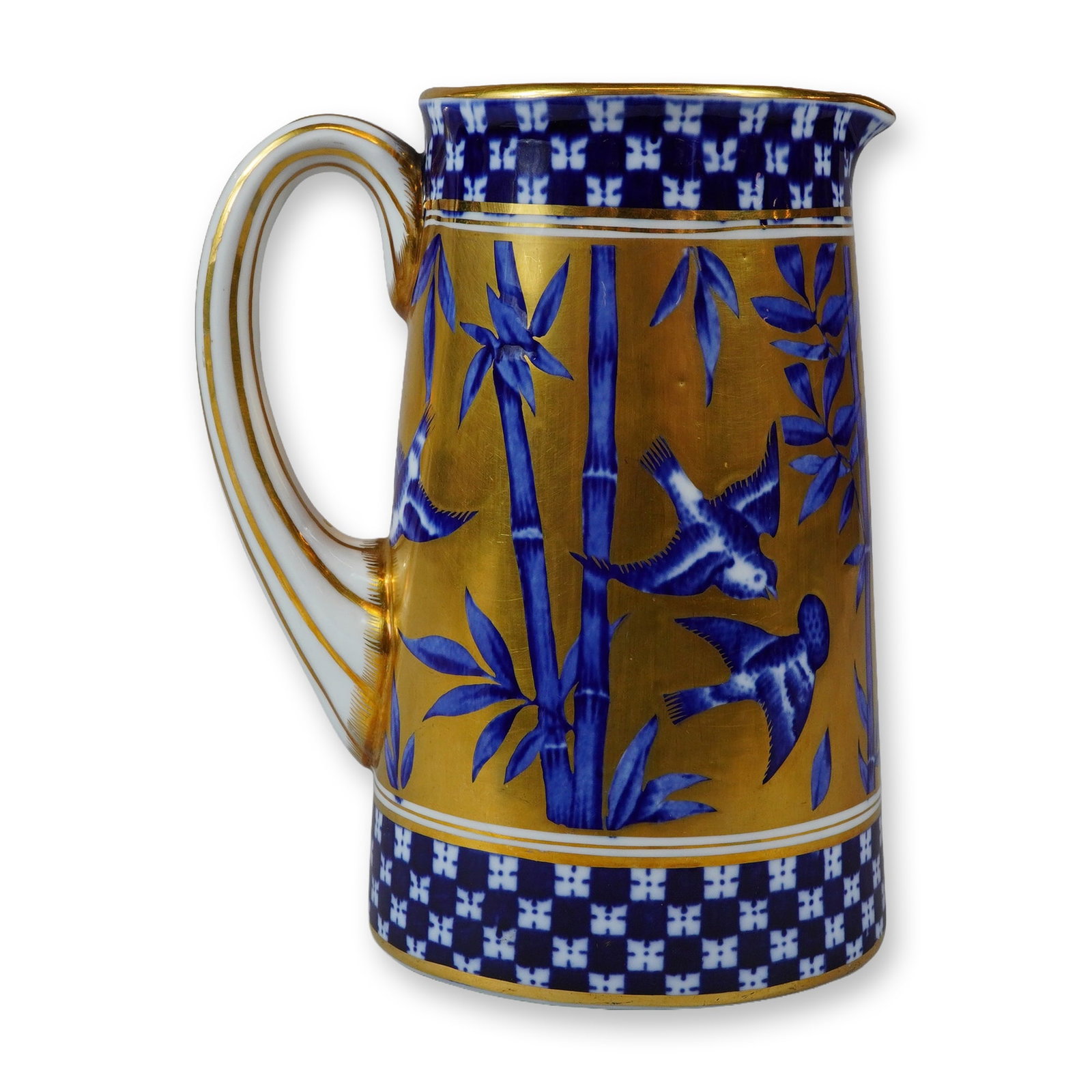 Coalport Porcelain Gilded Pitcher, Japanese Grove: The vessel features a tapered cylindrical form with a flared rim, a pinched pouring spout, and a white scroll handle accented with gold gilt lining. The body is finished in a rich matte gold gilding a