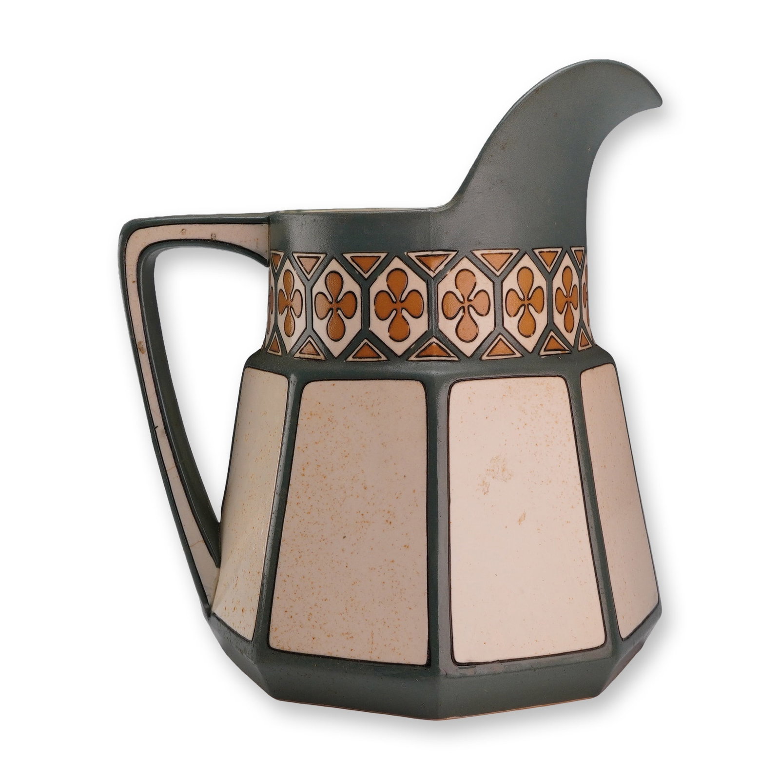 Villeroy and Boch Mettlach Jugendstil Stoneware Milk Pitcher Model 3321: A Villeroy and Boch Mettlach stoneware milk pitcher of octagonal, faceted form, exhibiting Jugendstil design influences. The body features recessed panels in a cream color with a mottled texture, sepa