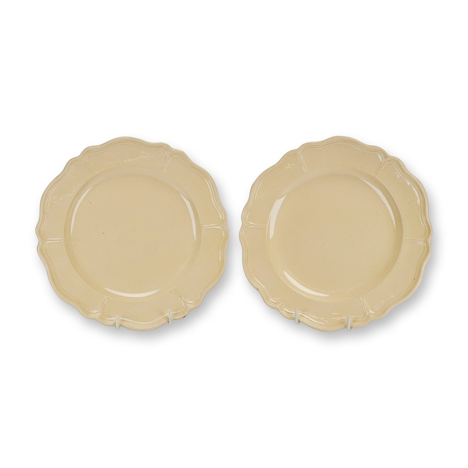 2pc English Creamware Plates with Lobed Rims, ca. 1770: A pair of English lead-glazed earthenware plates, commonly referred to as creamware, dating to circa 1770. Each plate is circular in form, featuring a molded, lobed rim with decorative lines that foll
