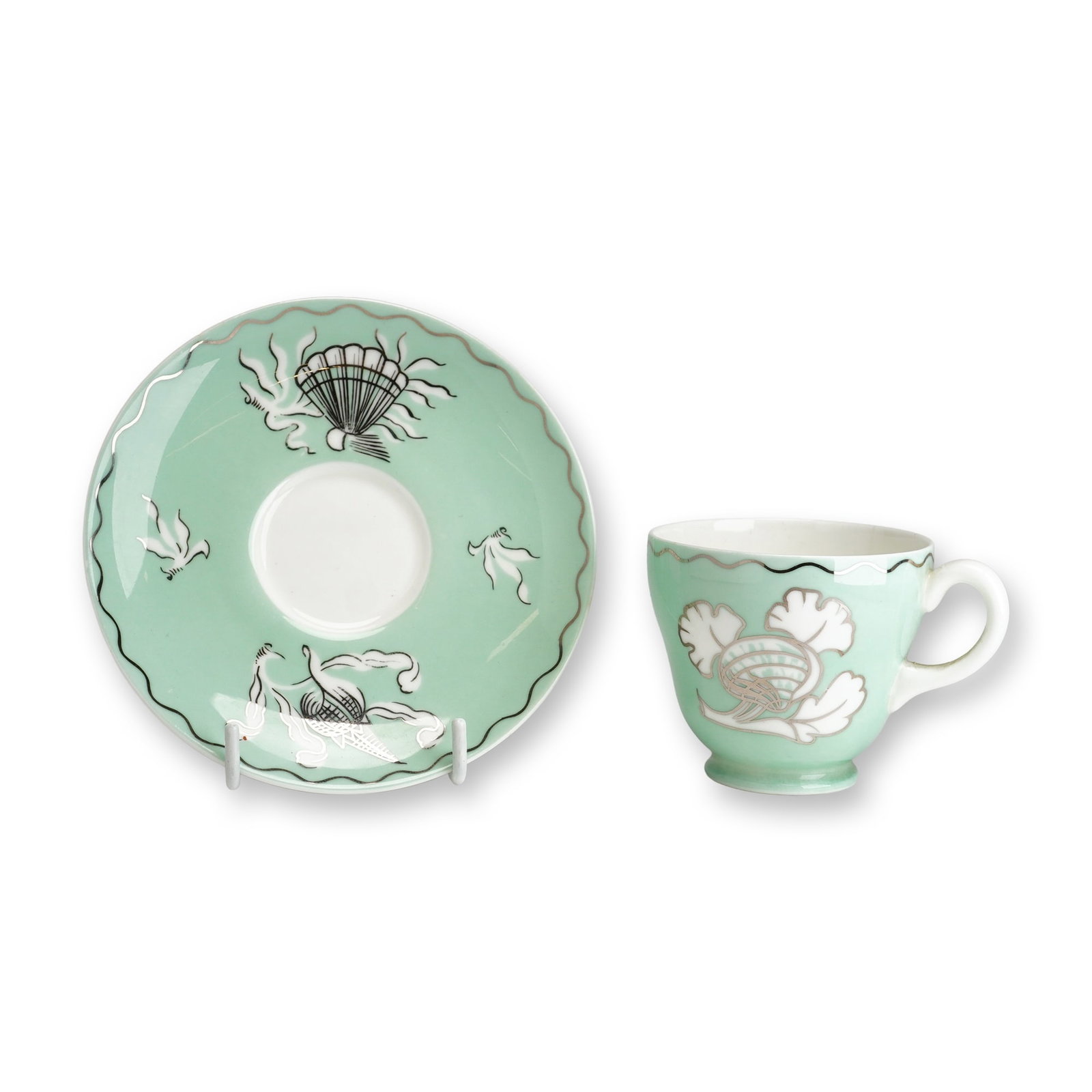 2pc Wedgwood Bone China Cup and Saucer with Platinum Shell Design by Victor Skellern: This set consists of a Wedgwood bone china coffee cup and saucer featuring a platinum shell design by Victor Skellern, dating to approximately 1937. Both pieces are decorated with a solid mint-green g