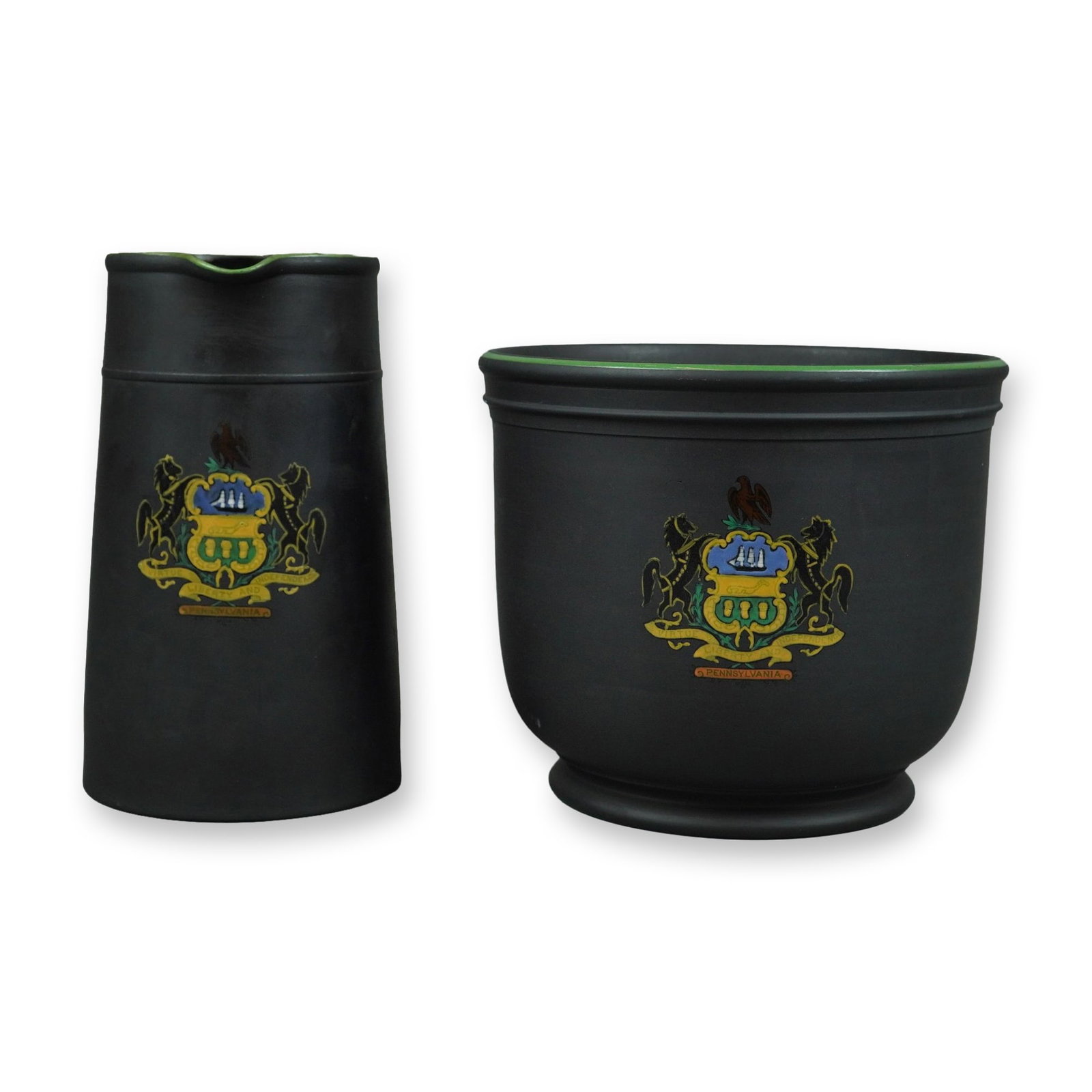 2pc Wedgwood Black Basalt Stoneware Vessels with Pennsylvania State Coat of Arms: This 2pc Wedgwood set consists of a pitcher and a bowl crafted from fine-grained, unglazed black basalt stoneware. Both pieces feature brightly enameled decoration depicting the coat of arms for the C