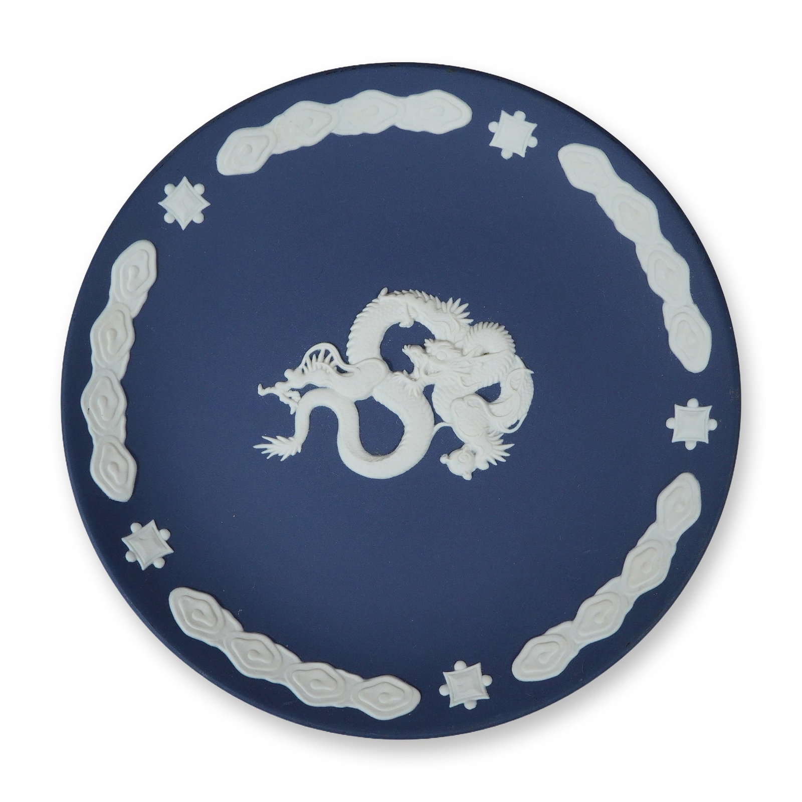 Wedgwood Blue Jasperware Chinese Dragon Plate: A small circular Wedgwood Jasperware plate featuring a blue matte ground with white relief-applied decorations. The central motif depicts a detailed Chinese-style dragon holding a sacred pearl. The bo