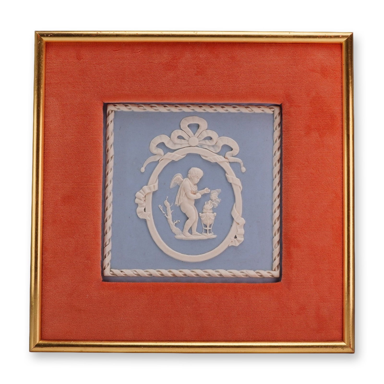 Wedgwood Blue and White Jasperware Framed Plaque with Cherub Design: A square Wedgwood jasperware plaque featuring sprigged decoration in white relief on a light blue ground. The central neo-classical motif depicts a winged cherub or Cupid tending to a flaming tripod u