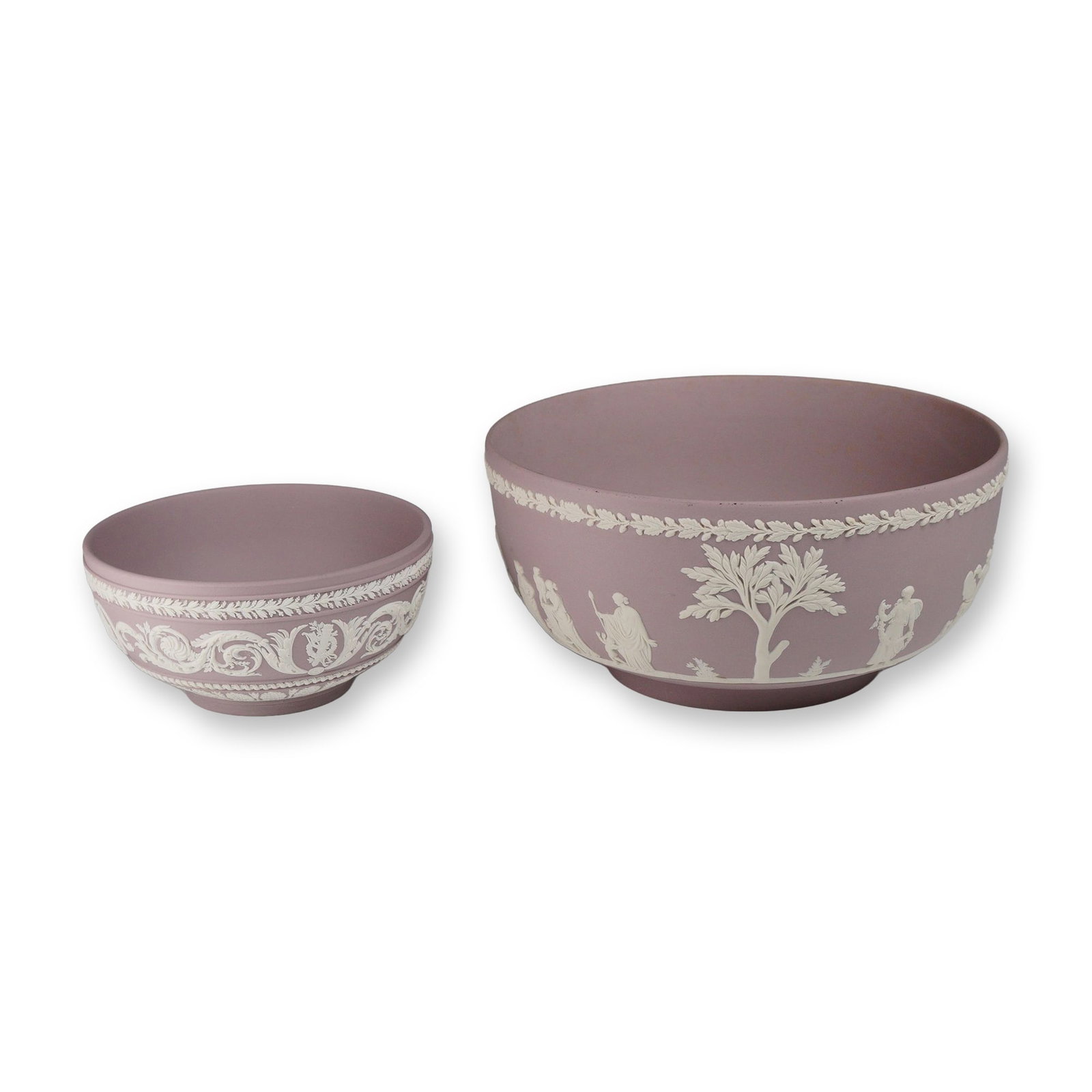 2pc Wedgwood Lilac Jasperware Bowls: A pair of Wedgwood lilac jasperware stoneware bowls with applied white relief decoration. The larger sacrifice fruit bowl features a continuous classical scene with Greco-Roman figures and a central t