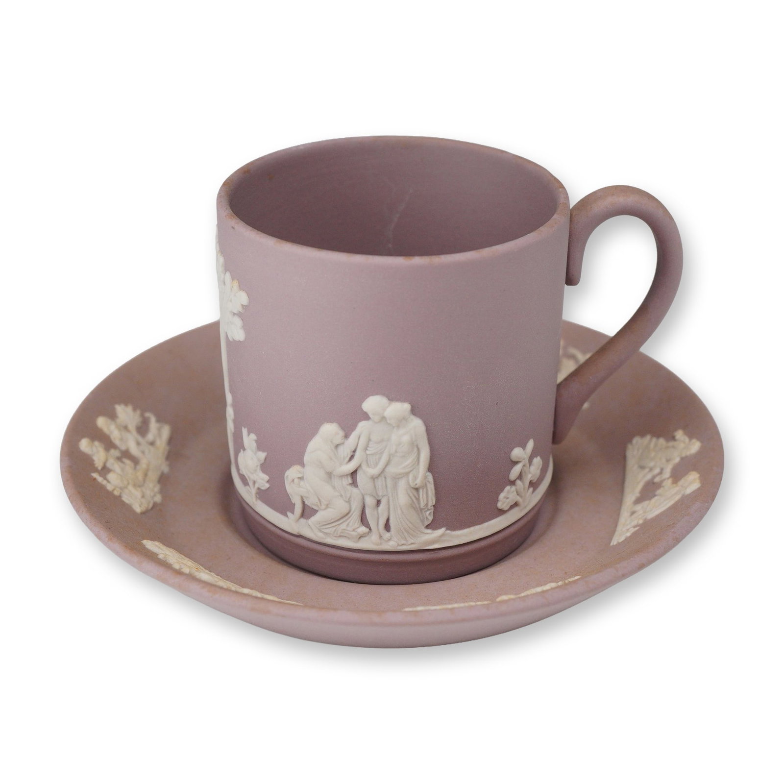 2pc Wedgwood Lilac Jasperware Demitasse Cup and Saucer: This 2-piece set consists of a Wedgwood lilac jasperware demitasse cup and saucer featuring applied white bas-relief neoclassical decorations. The set is crafted from a matte, unglazed lilac stoneware