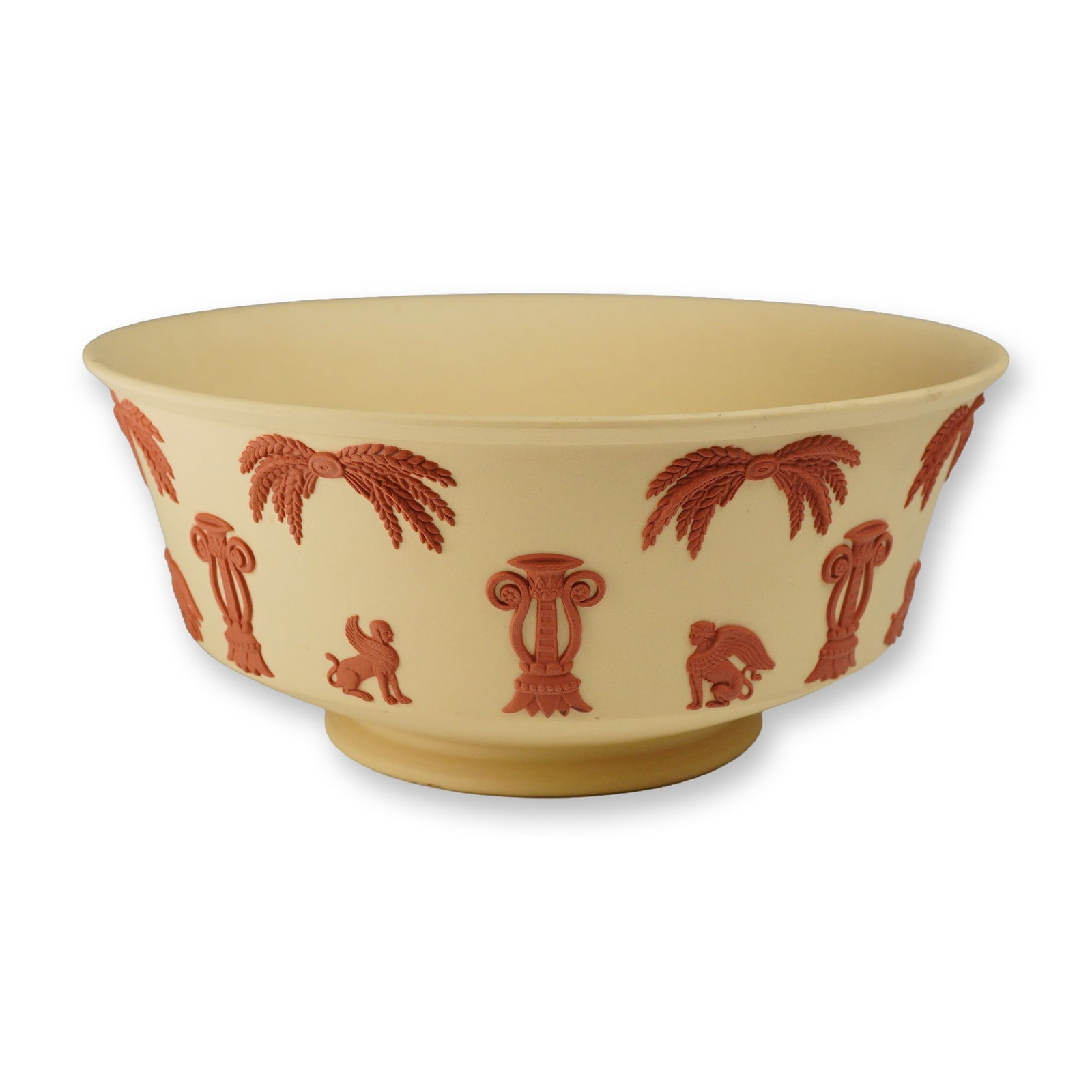 Wedgwood Primrose Yellow and Terra Cotta Jasperware Egyptian Revival Bowl: A Wedgwood Jasperware bowl featuring a primrose yellow stoneware body with applied terra cotta-colored sprigged decoration. The decoration follows an Egyptian Revival theme, showcasing alternating mot