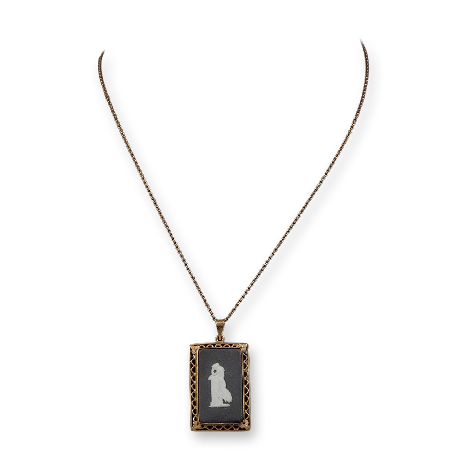 Wedgwood Black Basalt Jasperware and 14 Karat Gold Pendant Necklace: A vintage pendant necklace featuring a rectangular black basalt jasperware medallion manufactured by Wedgwood. The central medallion depicts a white bas-relief neoclassical woman in draped robes stand