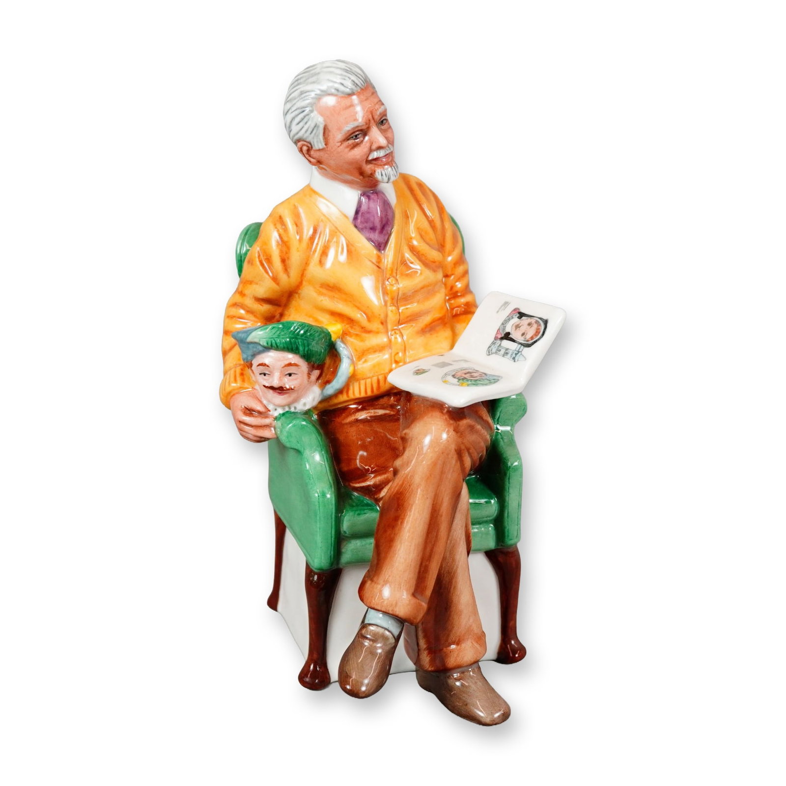Royal Doulton Porcelain Figurine, Pride and Joy HN2945: Part of the RDICC series. Designed by Robert Tabbenor. Hand-painted figure issued exclusively for members of the Royal Doulton International Collectors Club. Depicts a seated man wearing an orange swe
