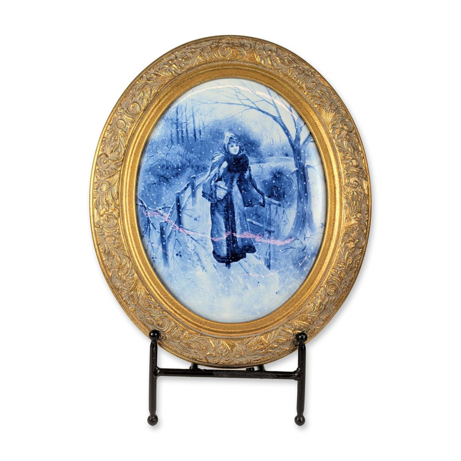 Royal Doulton Blue Children Series Ceramic Plaque: Oval ceramic plaque from the Blue Children series, featuring a monochrome blue scene of a woman in winter attire with a basket walking through a snowy forest. Signed A.E. Simpson in the lower right ar