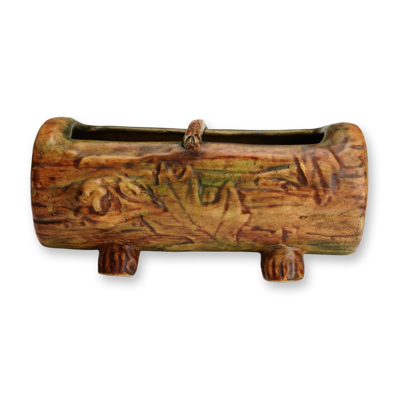 Weller Pottery Log Planter, Woodcraft: This earthenware planter is from the Woodcraft line, dating to the 1920s. The piece is relief-molded in a naturalistic faux bois style to resemble a log, featuring realistic bark texture, knots, and a