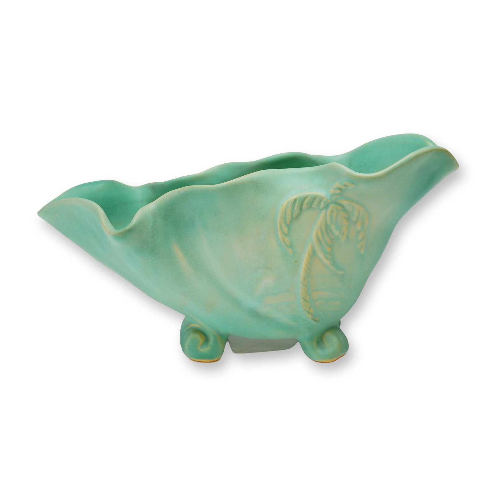 Weller Pottery Turquoise Shell Planter: The vessel features an asymmetric, ruffled shell-like form supported by four scrolled feet. The piece is finished in a matte turquoise glaze with cream-colored highlights that accentuate a relief-mold