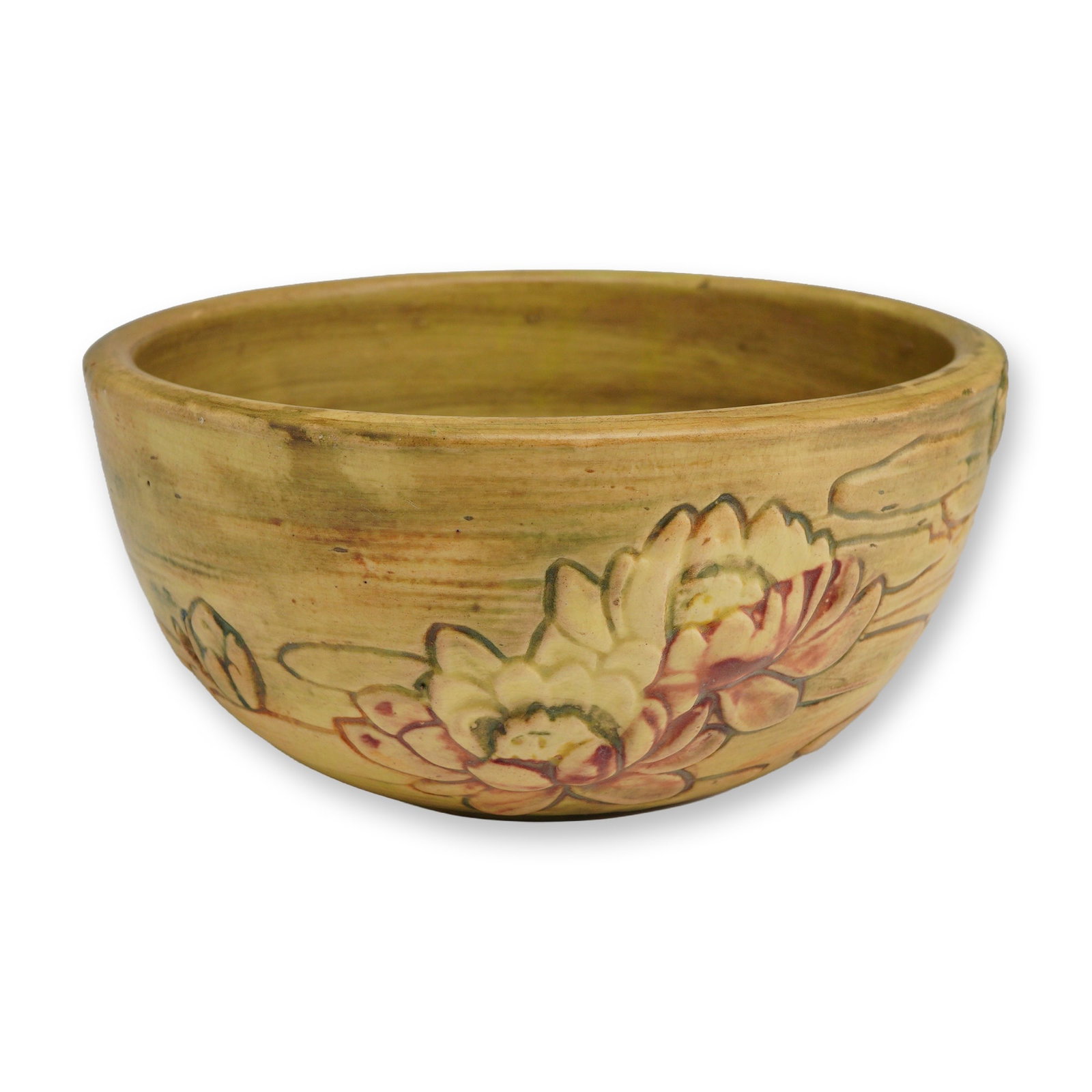 Weller Pottery Bowl, Water Lily: This Weller art pottery earthenware bowl is finished in the Water Lily pattern, featuring relief-molded stylized water lily motifs in shades of dusky rose and sage green. The exterior background displ