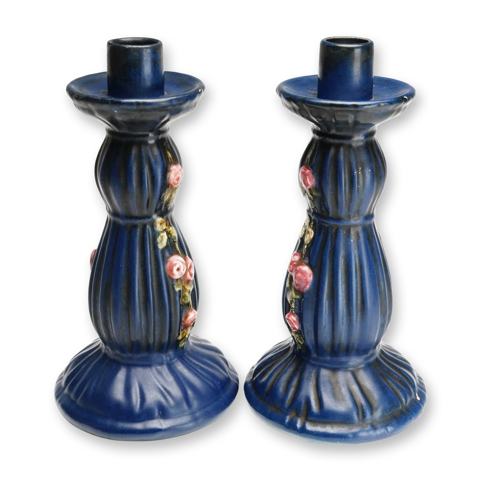 Weller Pottery Flower and Leaf Candleholders, Blue Drapery: A pair of antique glazed ceramic candlesticks produced by Weller Pottery in the Blue Drapery pattern, dating to approximately 1915. Each piece features a deep cobalt blue finish accented with black-ru
