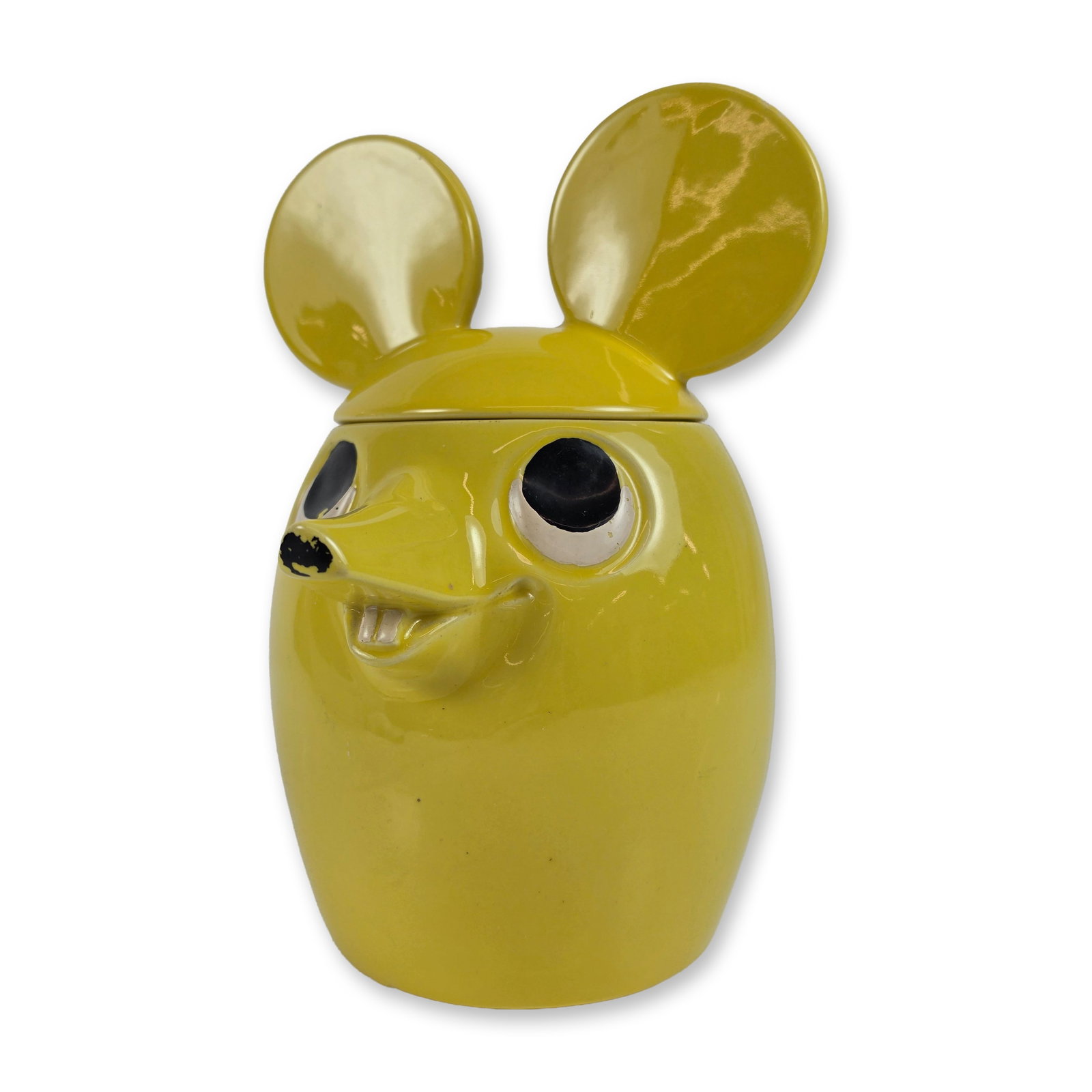 McCoy Yellow Ceramic Mouse Cookie Jar: The piece is finished in a vibrant yellow glaze with a removable lid featuring large circular ears. The face includes applied ceramic eyes, a pointed snout, and two front teeth. An applied, curved tai