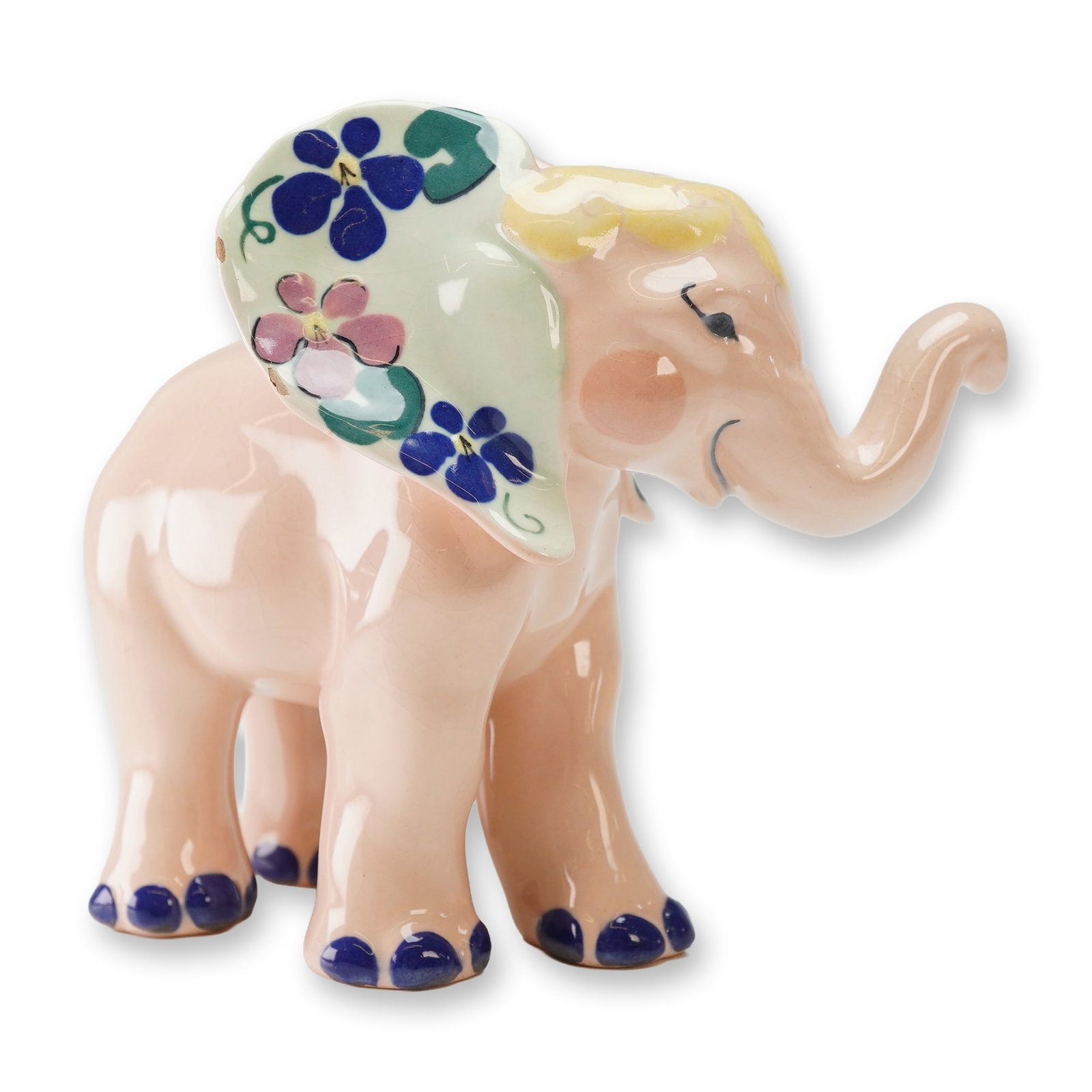Kay Finch California Pottery Figurine, Baby Elephant: This mid-century ceramic figure is finished in a glossy light pink glaze and features an upturned trunk with a smiling facial expression. The large cream-colored ears are decorated with hand-painted p