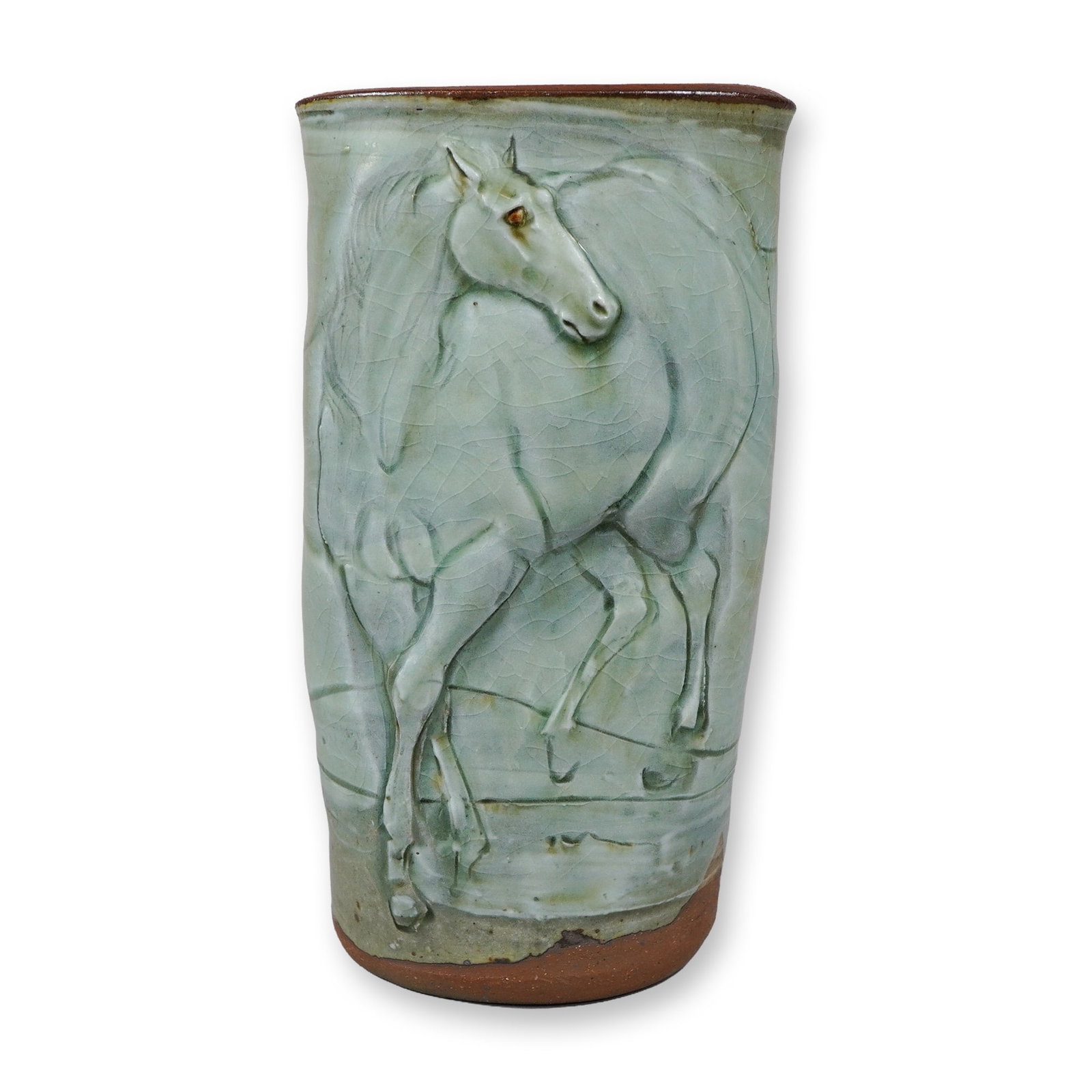 Susan Greenleaf Studio Pottery Equine Series Bas Relief Vase: A tall, slightly flattened cylindrical studio pottery stoneware vase by American ceramicist Susan Greenleaf. The front of the vessel features a prominent bas-relief carving of a horse, depicted from t