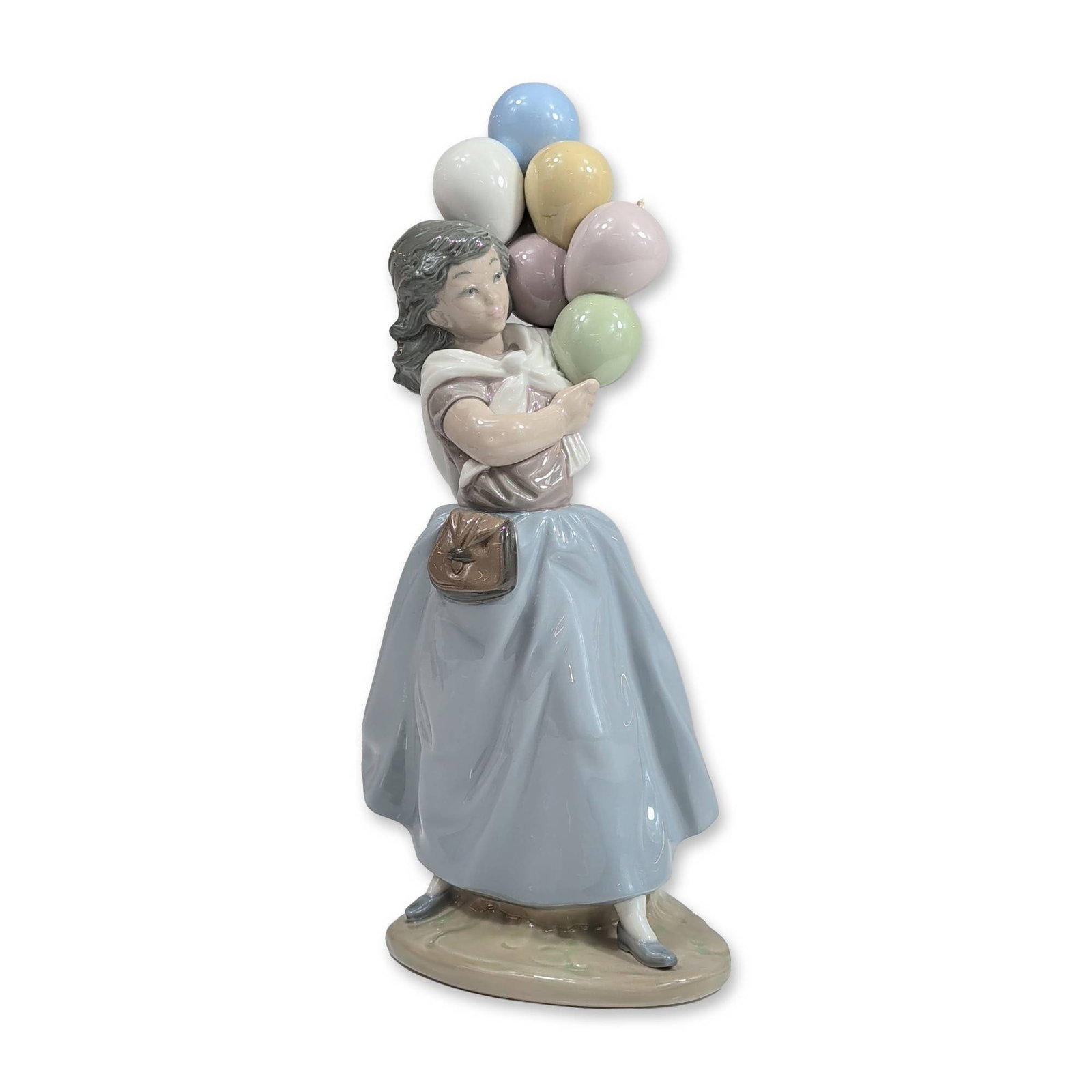 Lladro Porcelain Figurine, Balloons for Sale 1005141: Lladro Spanish glazed porcelain figurine titled Balloon Seller, model number 5141, designed by sculptor Salvador Debon. The figurine depicts a young girl dressed in a long blue skirt and mauve top wit