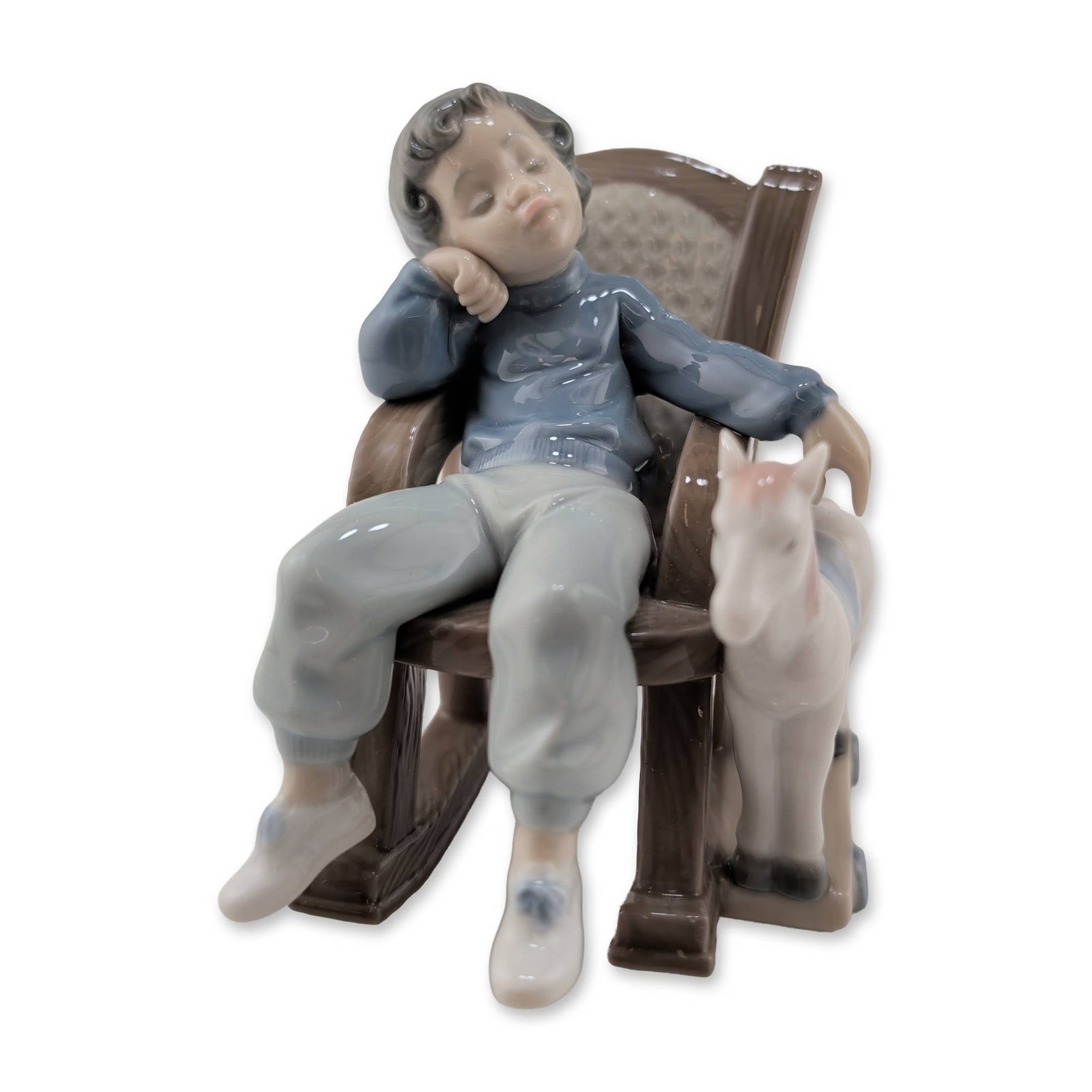 Lladro Glazed Porcelain All Tuckered Out Figurine 01005846: Lladro Spanish glazed porcelain figurine titled All Tuckered Out, model number 5846. The piece depicts a young boy asleep in a rocking chair with a faux-wood grain finish and caned-style backrest, acc