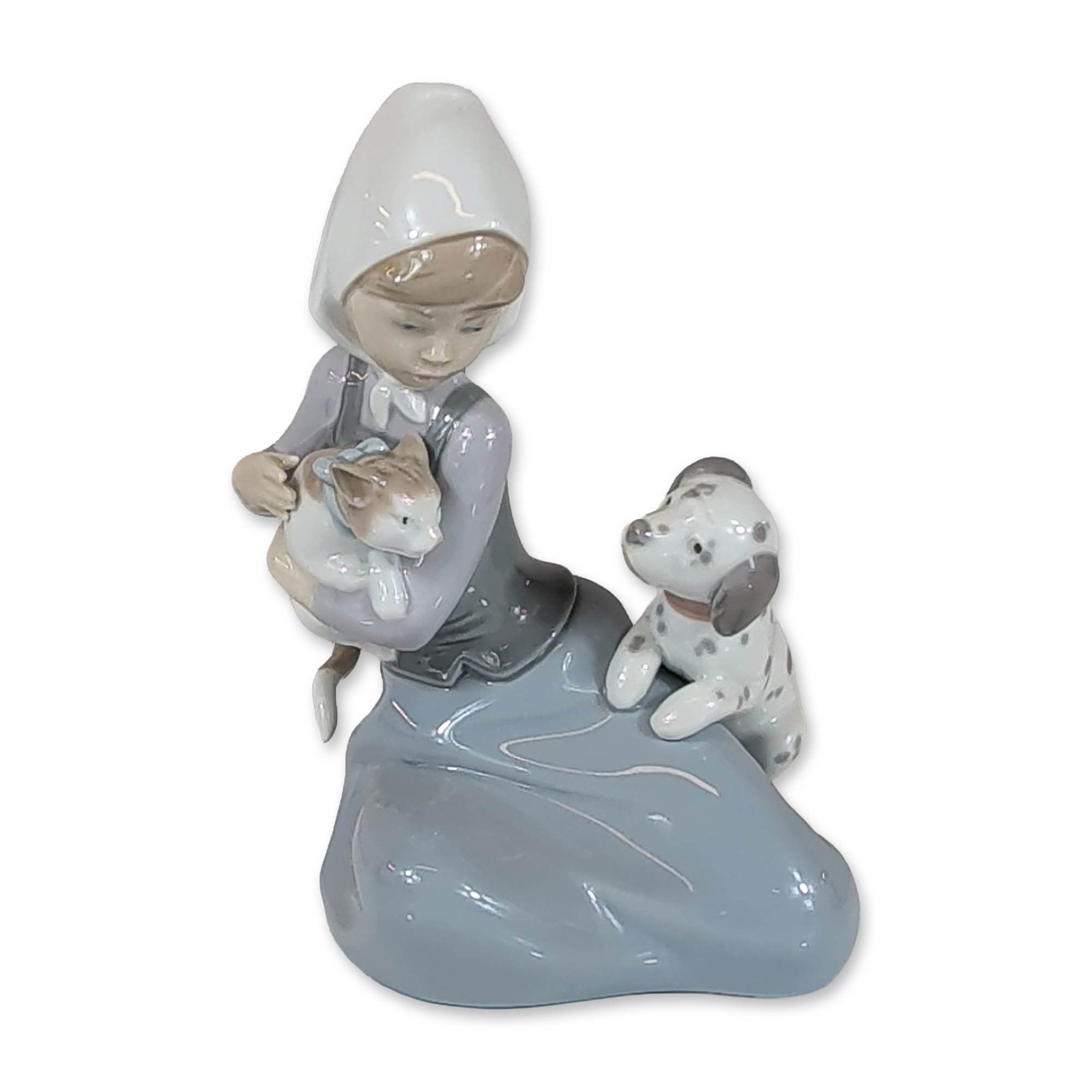 Lladro Porcelain Figurine, Little Friskies 01005032: Lladro (Spain) glazed porcelain figurine titled Little Friskies, model number 5032, designed by Juan Huerta. The composition depicts a seated young girl wearing a white bonnet and long skirt, cradling