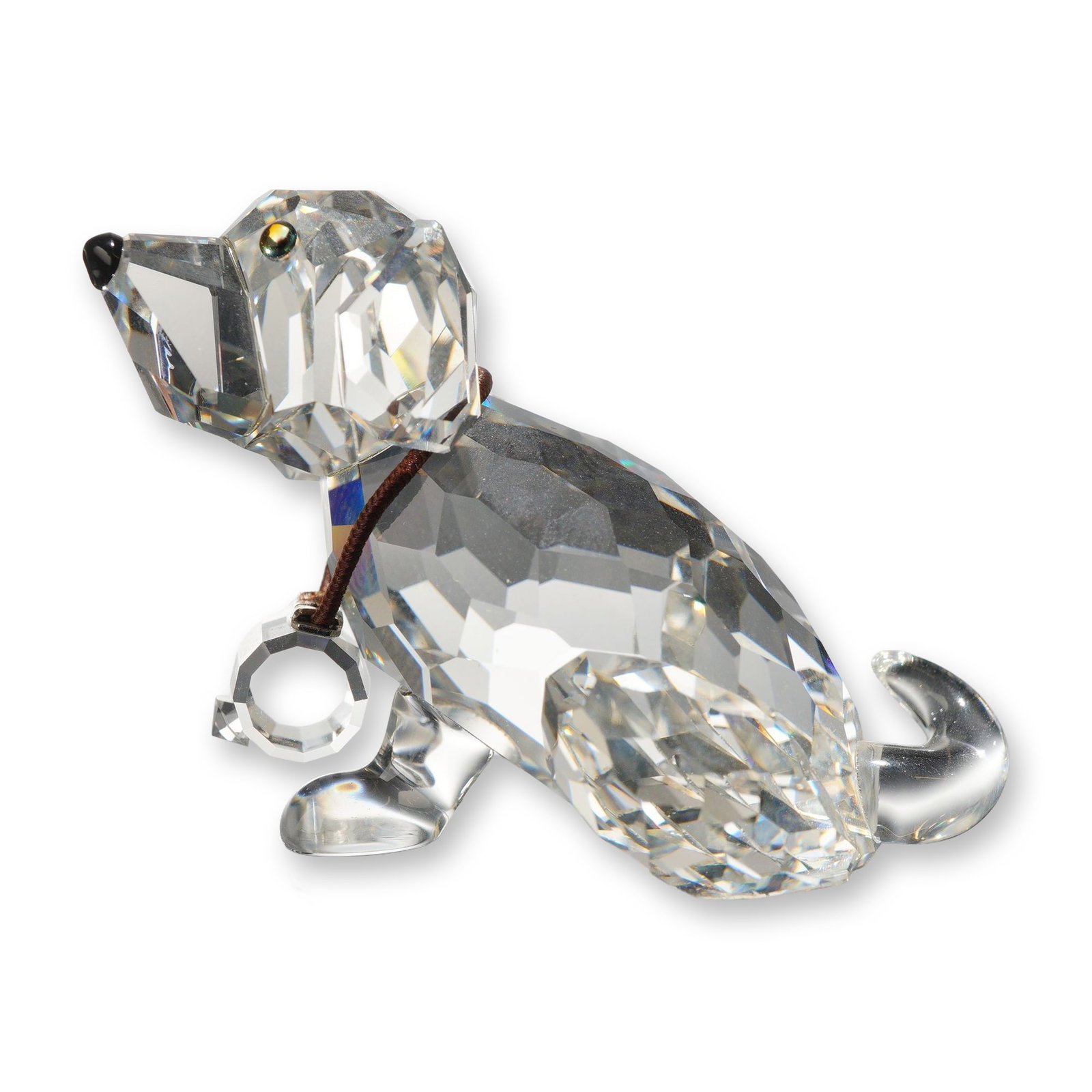 Swarovski Crystal St. Bernard Puppy Figurine: Swarovski Silver Crystal figurine of a St. Bernard puppy in faceted clear lead crystal. The figure is modeled in a seated position with amber-toned eyes and a black crystal nose. It features a brown c