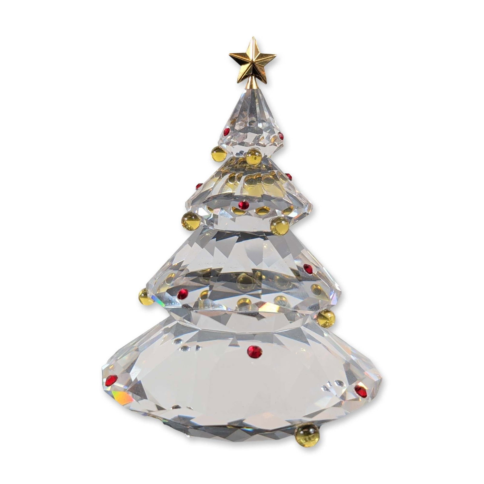 Swarovski Crystal Faceted Christmas Tree Figurine: The design features four graduated tiers of clear faceted lead crystal resting on a wide, faceted circular base. The tree is embellished with applied amber and red crystal spherical ornaments and is c