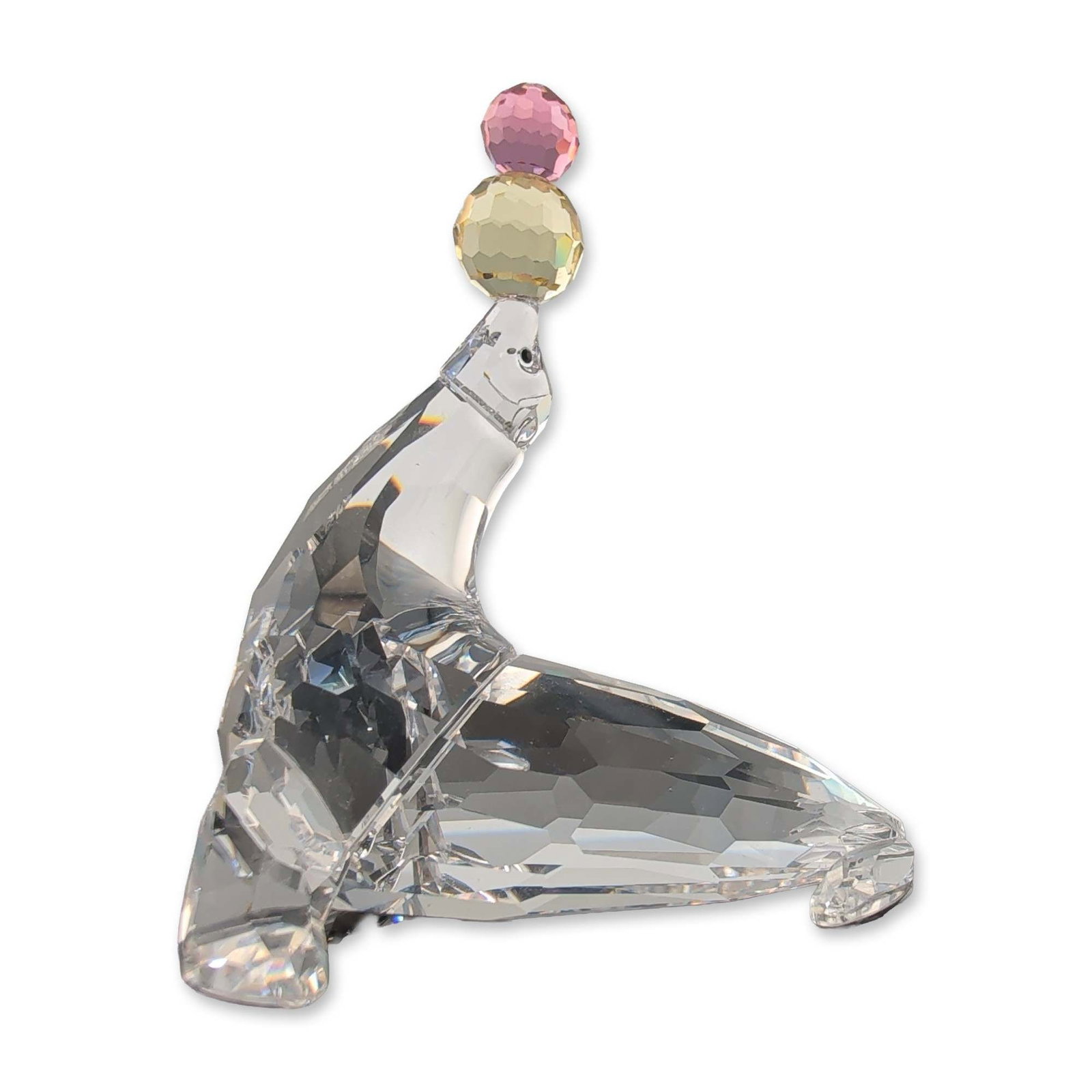 Swarovski SCS Crystal Playing Seal Figurine: Swarovski Crystal Society (SCS) figurine, model 622526, titled Playing Seal. The piece is constructed from faceted clear lead crystal, featuring a seal in a balancing pose with inset black crystal eye