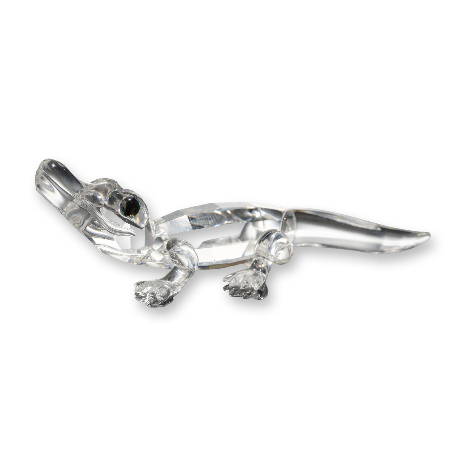 Swarovski Silver Crystal Alligator Figurine with Box: Swarovski. Miniature alligator figurine in faceted clear lead crystal, featuring a multifaceted body designed for light refraction with a smooth polished head, tail, and legs. The piece includes small